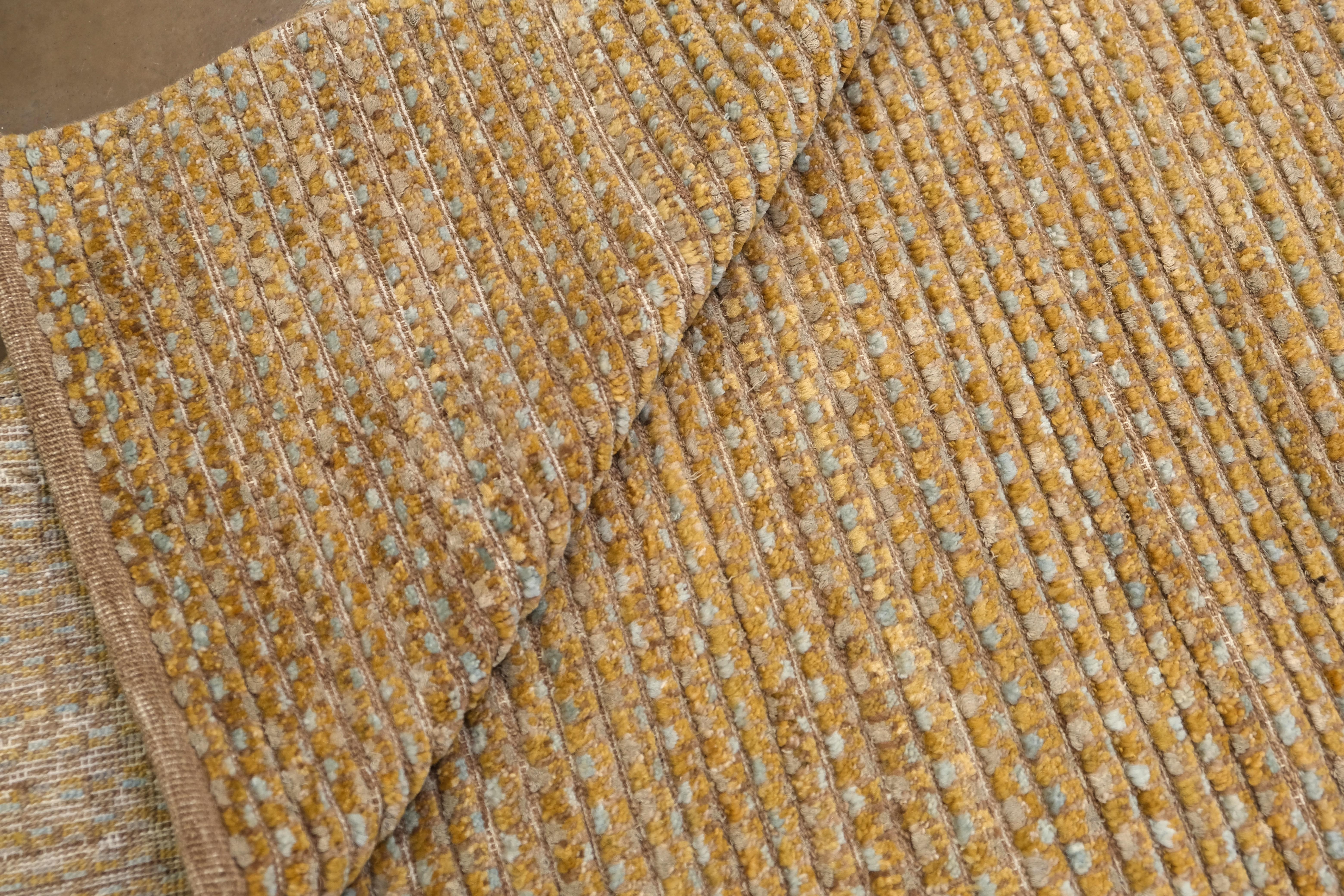 This exquisite hand-knotted rug, crafted from a luxurious blend of wool and silk, offers a perfect fusion of understated elegance and artisan craftsmanship. Measuring approximately 8'10