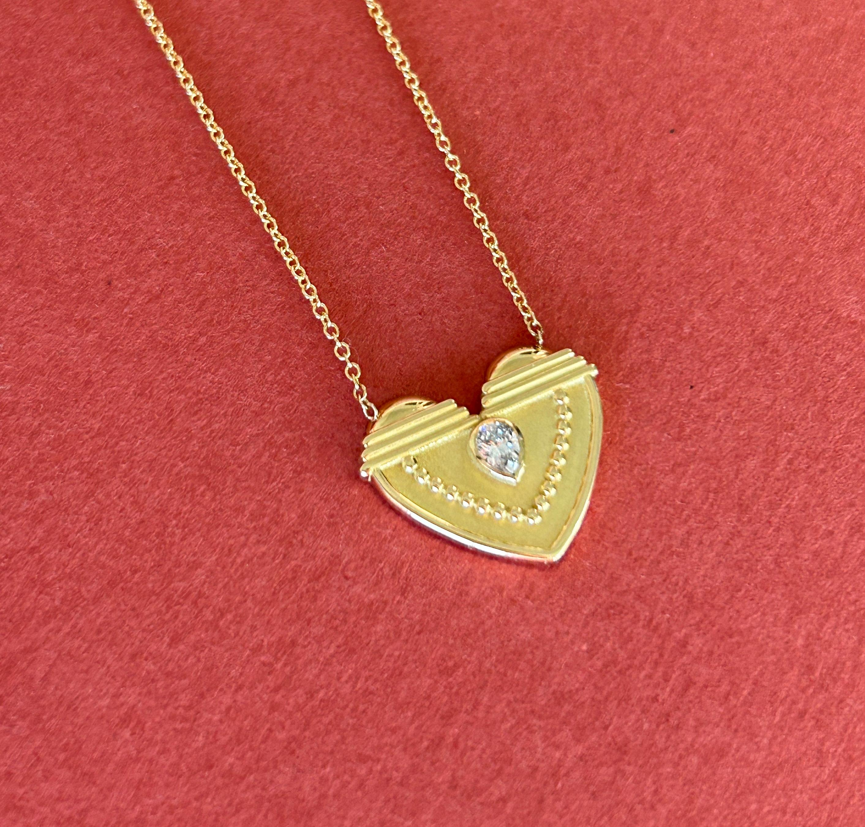 Contemporary Textured Heart Pendant in 18 Karat Gold With A Pear-Shaped Diamond
