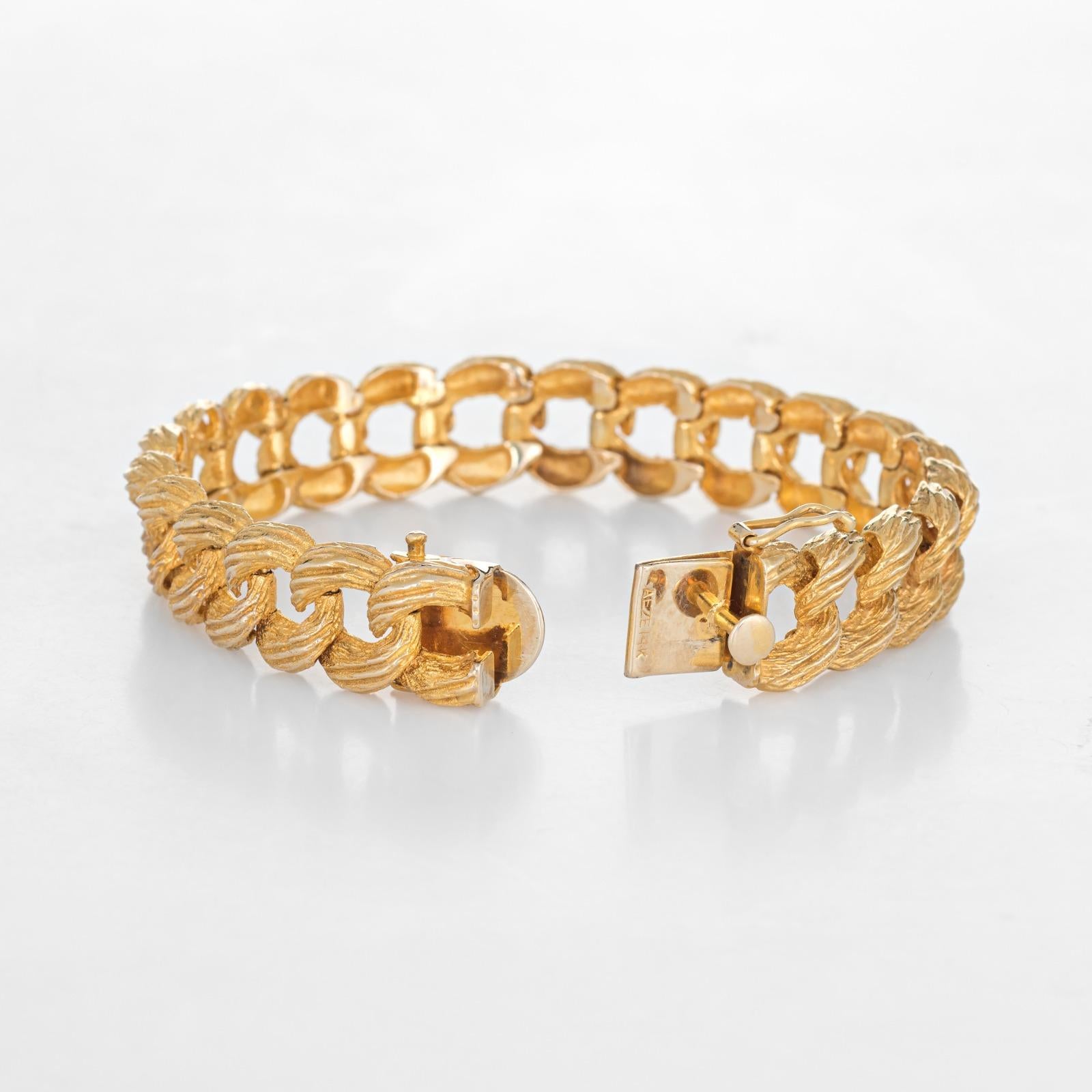 Finely detailed textured curb link bracelet crafted in 14 karat yellow gold (circa 1980s to 1990s). 

The curb link bracelet measures 12.5mm wide (0.49 inches) and features an organic like textured design, offering a subtle and warm glow to the