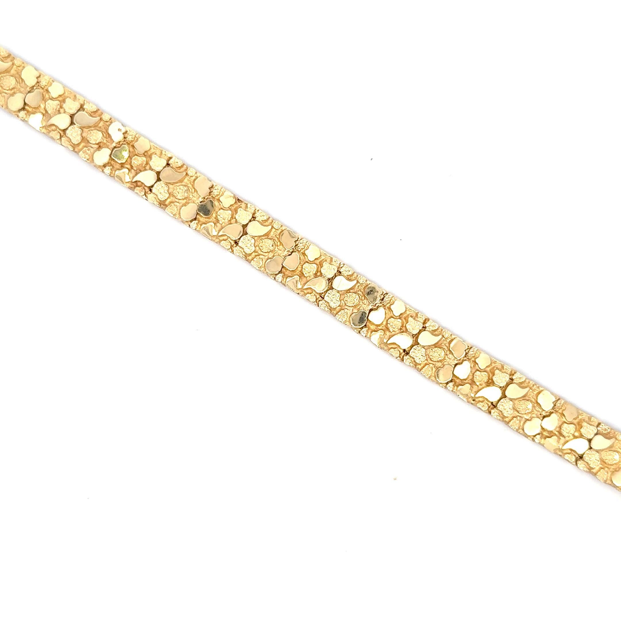 14 Karat Yellow Gold bracelet featuring a high polished and brushed finish stone motif design weighing 27.4 grams. 
