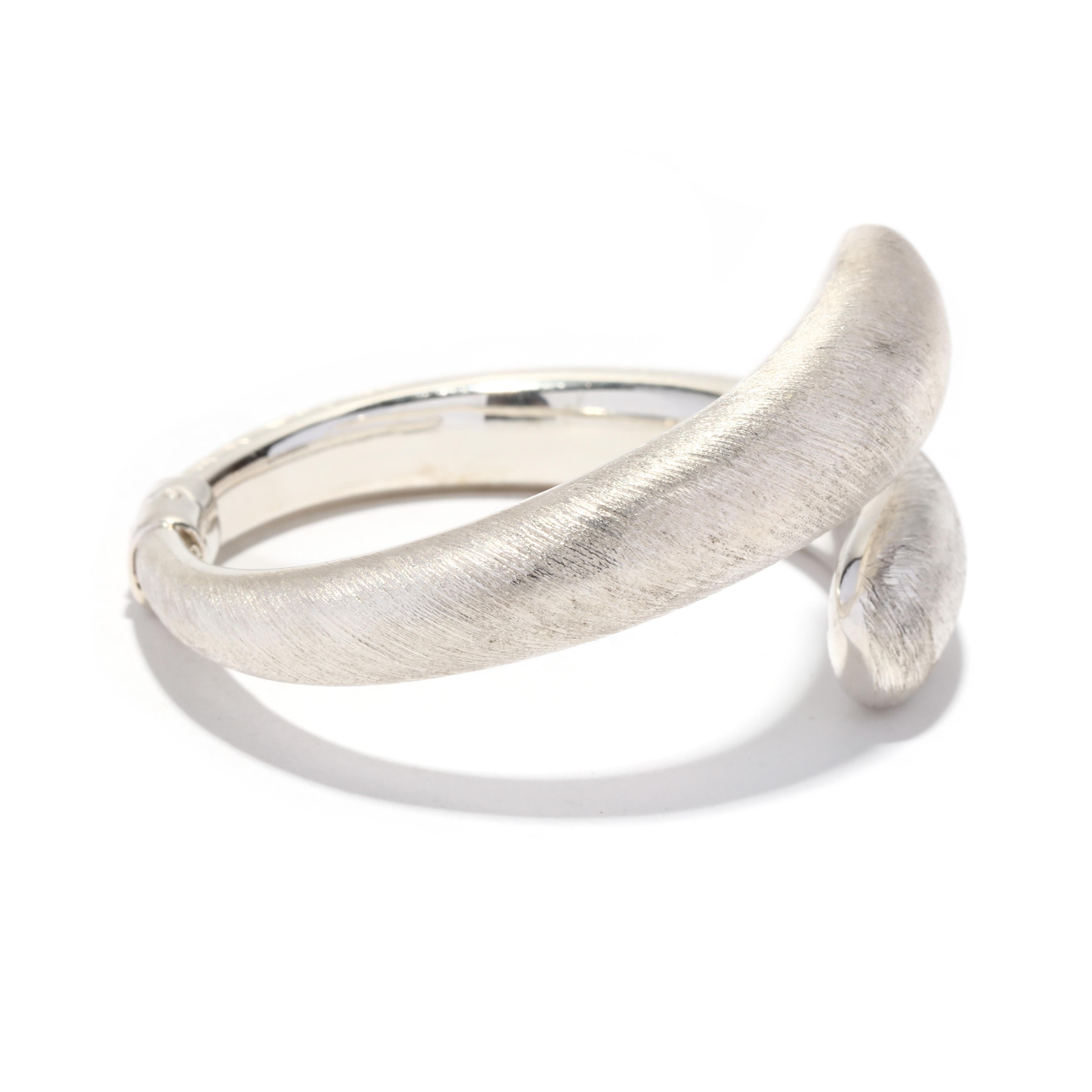 This handmade Italian sterling silver crossover bangle is truly unique. Featuring a textured design, this stunning bracelet is perfect for a special occasion or everyday wear. The bracelet measures 6.5 inches and is crafted from 925 Italian sterling