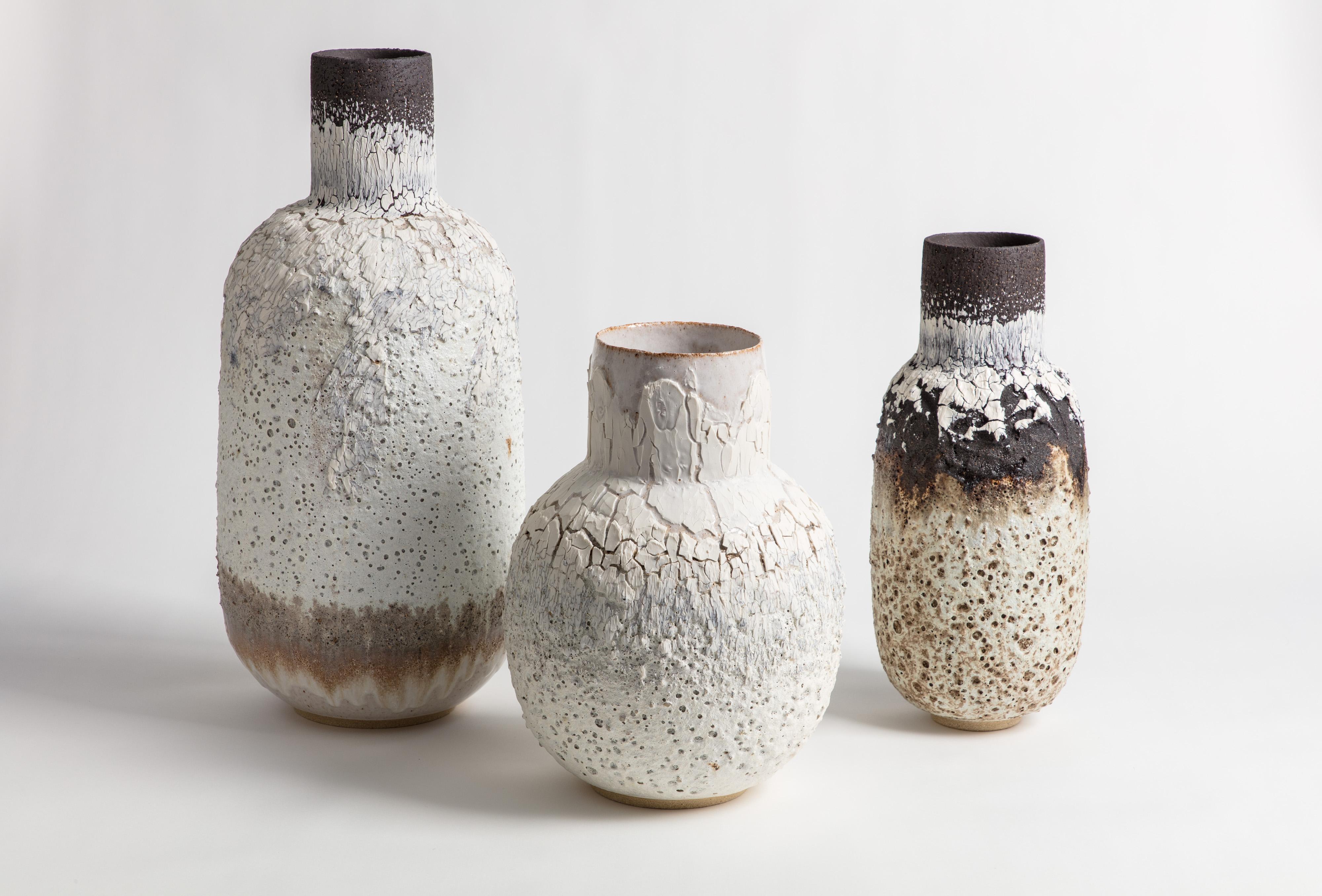 This medium heavily textured volcanic bottle shaped vessel with black and white glaze and markings. Made from black textured stoneware clay and porcelain engobe with the addition of lava stone.

Inspiration for the piece comes from the clay itself
