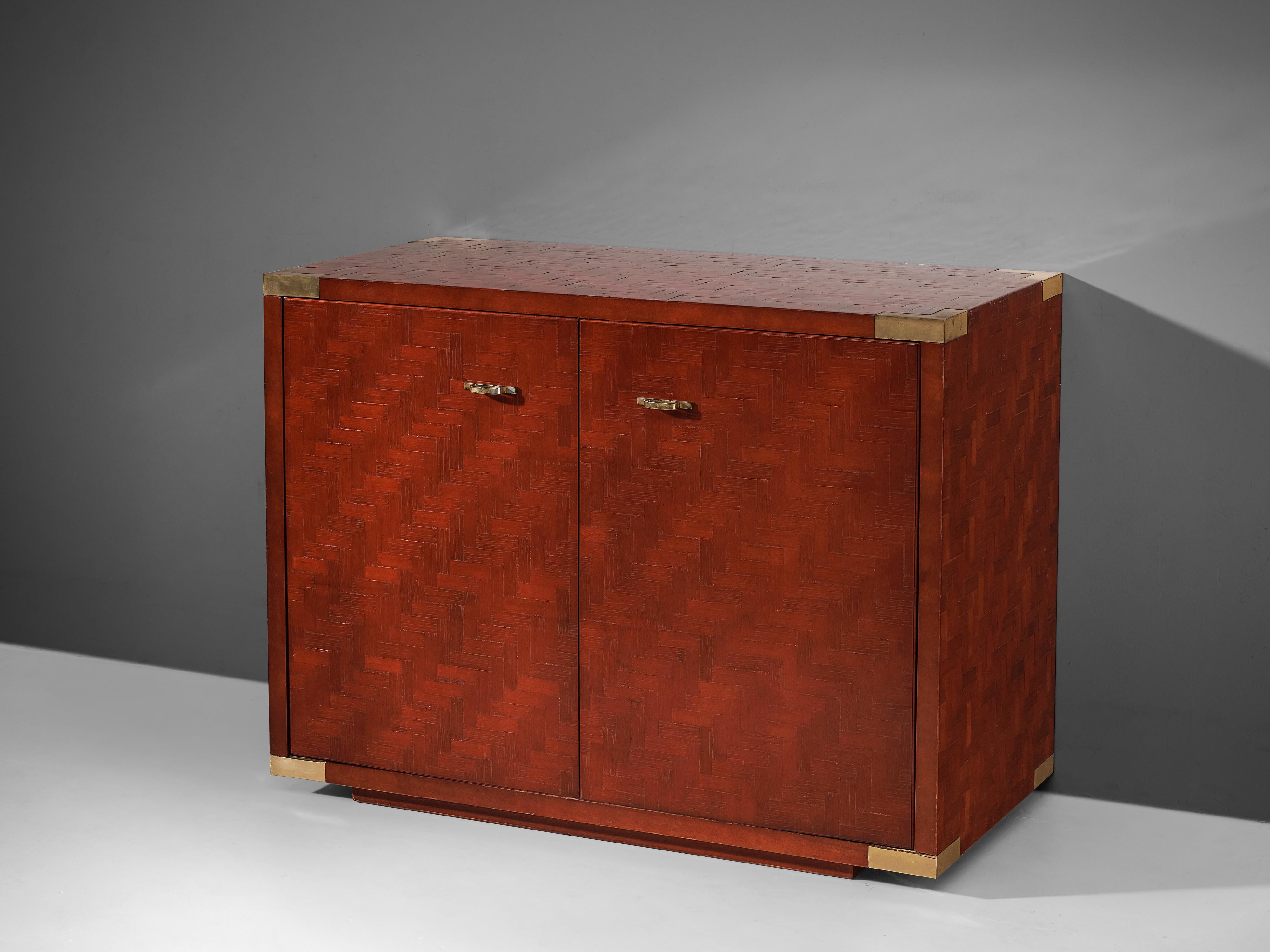 Cabinet, lacquered wood, brass, Europe, 1960s. 

This elegant cabinet is a good example of excellent woodworking by virtue of the red lacquered surface which consists of multiple rectangular wooden pieces, each placed according to a fixed pattern.