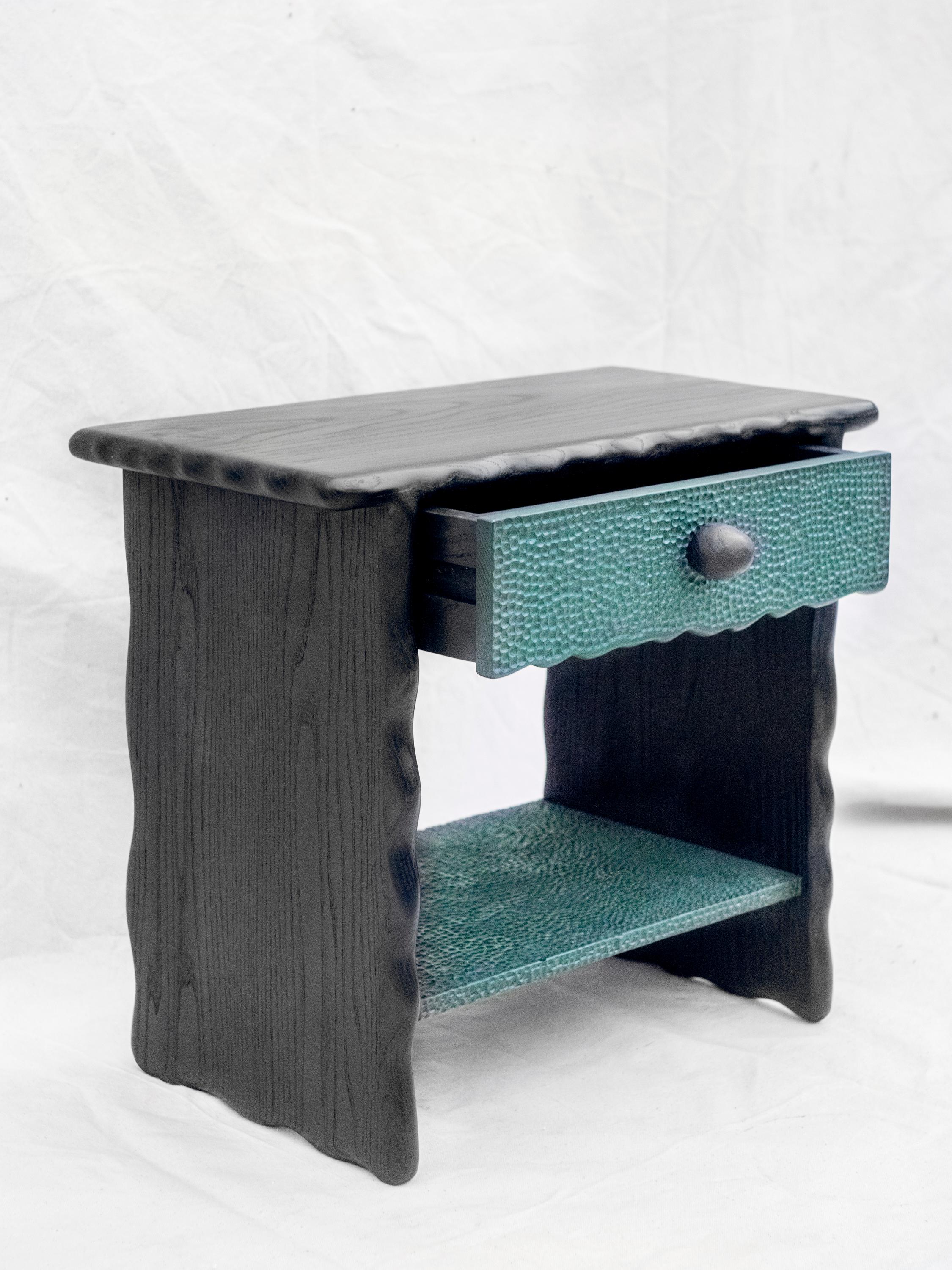 The T nightstand is hand sculpted from pigmented solid ash with a natural oil / wax finish. It was originally created in Brooklyn, New York, as a personal gift for the artist's brother’s new home. As such, it was designed to integrate the qualities