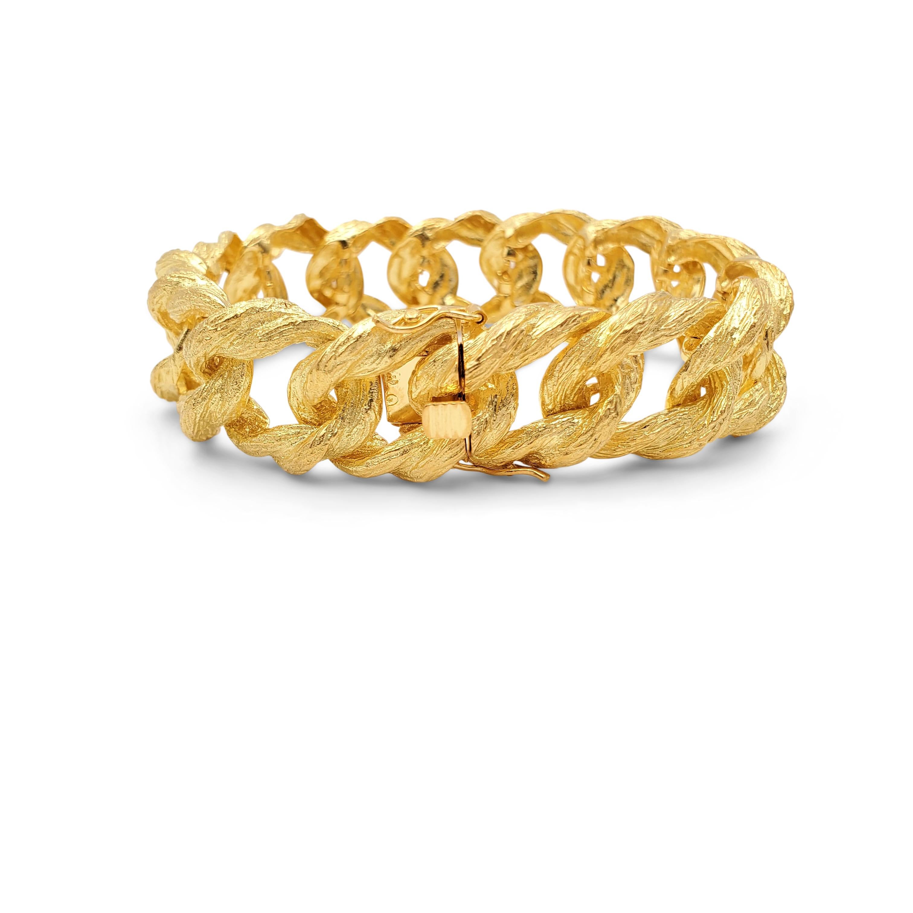 An extremely wearable curb link bracelet crafted in textured 18 karat yellow gold. Unintelligible marks on the tongue of bracelet. The bracelet measures 7 3/4 inches in length including the clasp. Not presented with the original box or papers. CIRCA