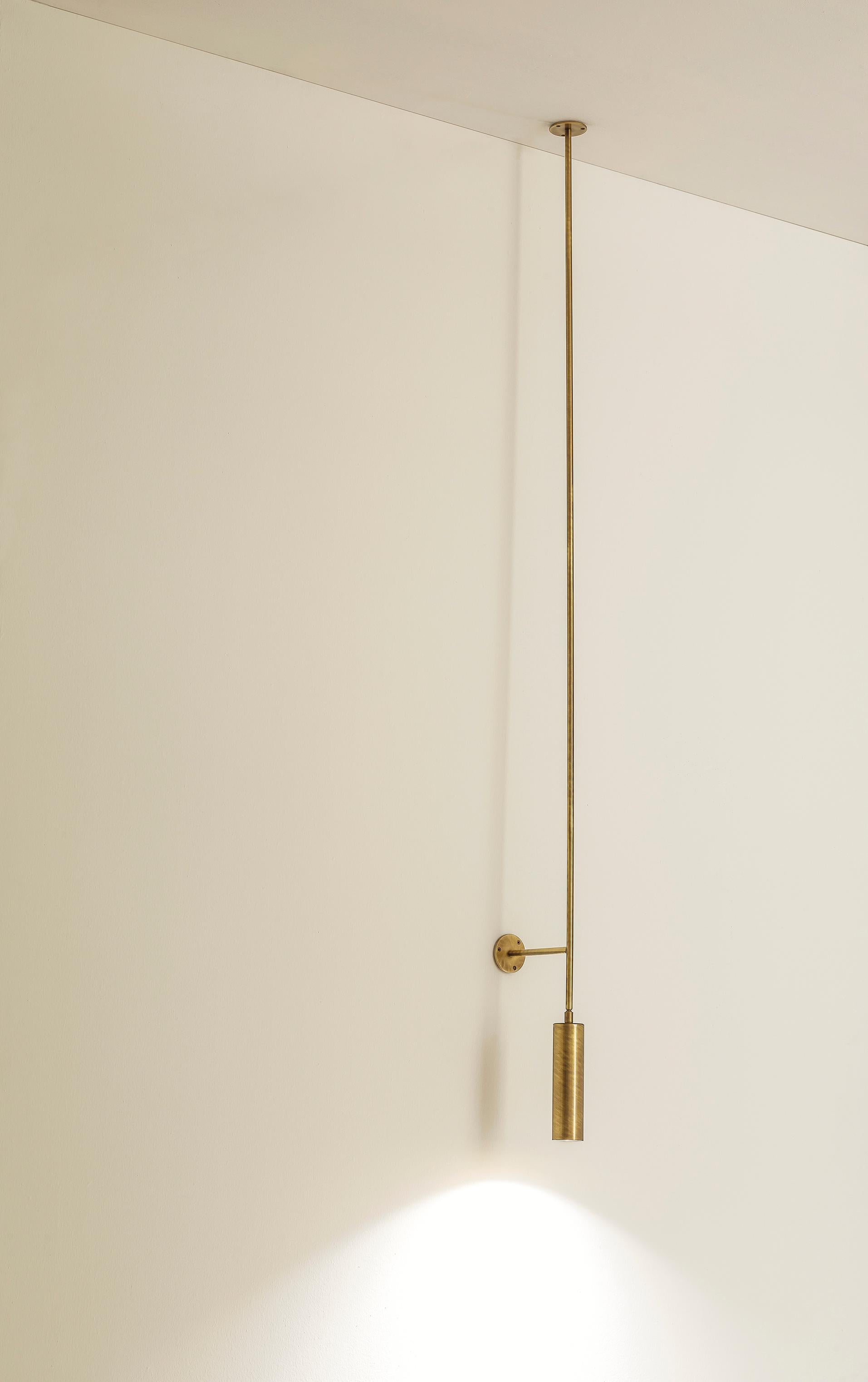 TF511 Ceiling Lamp in Satin Brass with an Orientable Tubular Diffuser by Daluce
Dimensions: Ø 16,6 x H 184 cm. 
Materials: Brass.

Available in different finish options: light satin burnished brass, medium satin burnished brass, and dark satin
