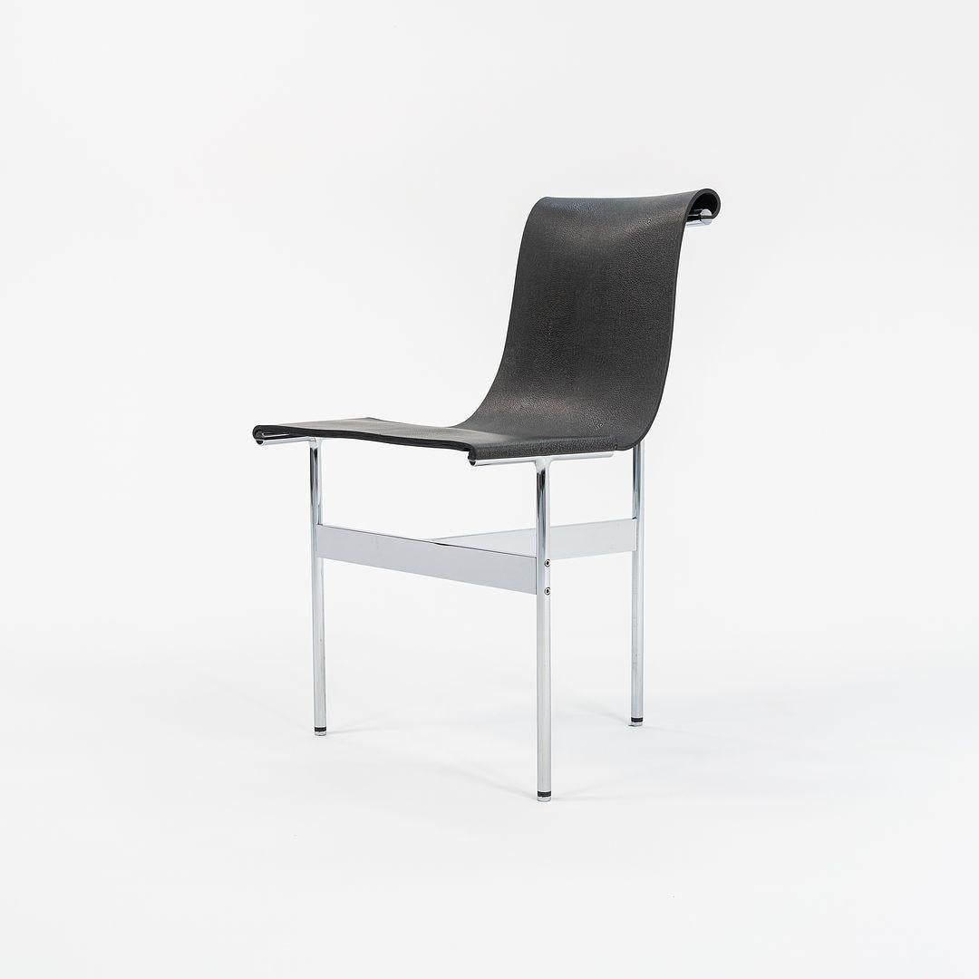 This is a TG-10 sling dining chair in black speckled leather with a polished chrome frame, produced by Gratz Industries. The chair was designed by Katavolos, Littell and Kelley in 1952 as part of the original Laverne Collection produced by Gratz