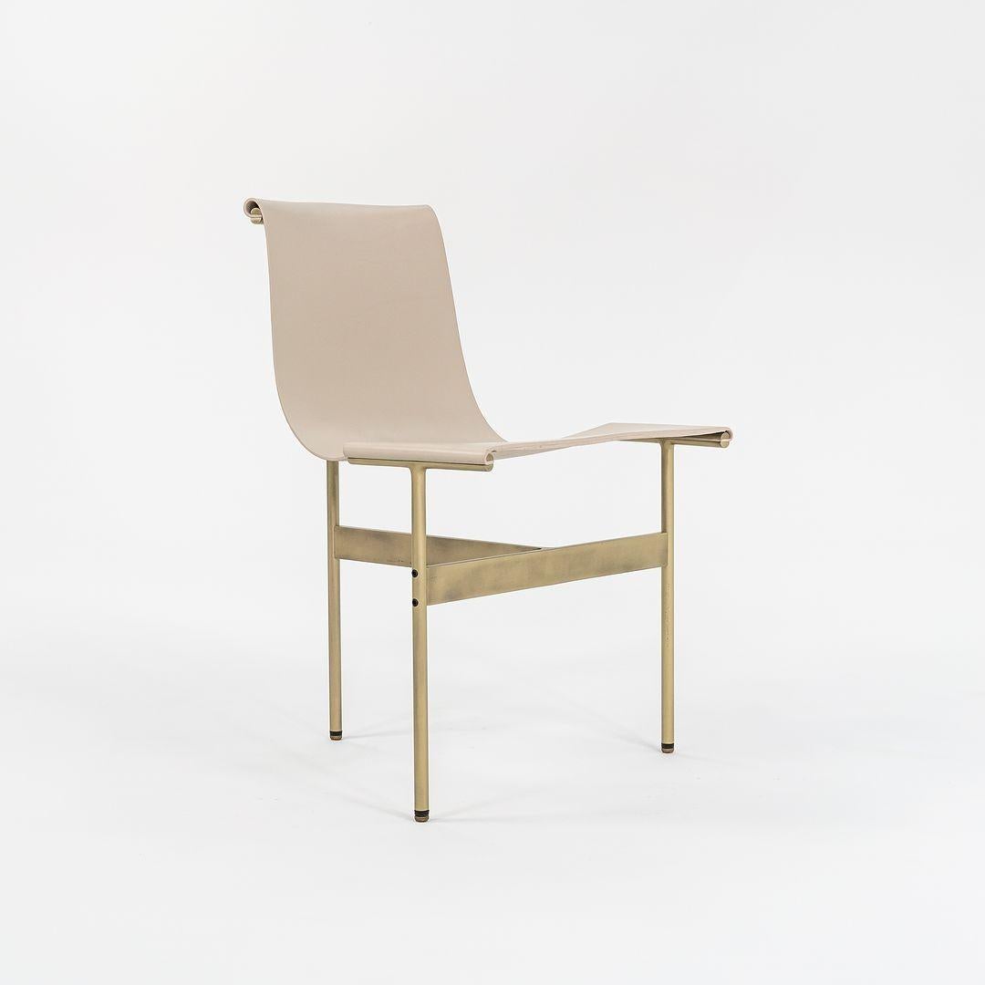 This is a pair of 2 (two) TG-10 sling dining chairs in cream leather with a light antique bronze frame, produced by Gratz Industries. The chairs were designed by Katavolos, Littell and Kelley in 1952 as part of the original Laverne Collection