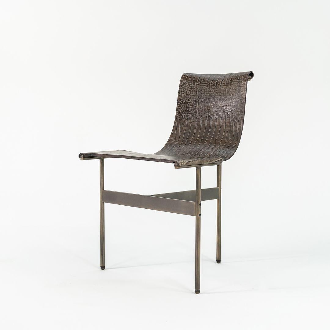 This is a TG-10 sling dining chair in faux crocodile leather with a medium antique bronze frame, produced by Gratz Industries. The chair was designed by Katavolos, Littell and Kelley in 1952 as part of the original Laverne Collection produced by