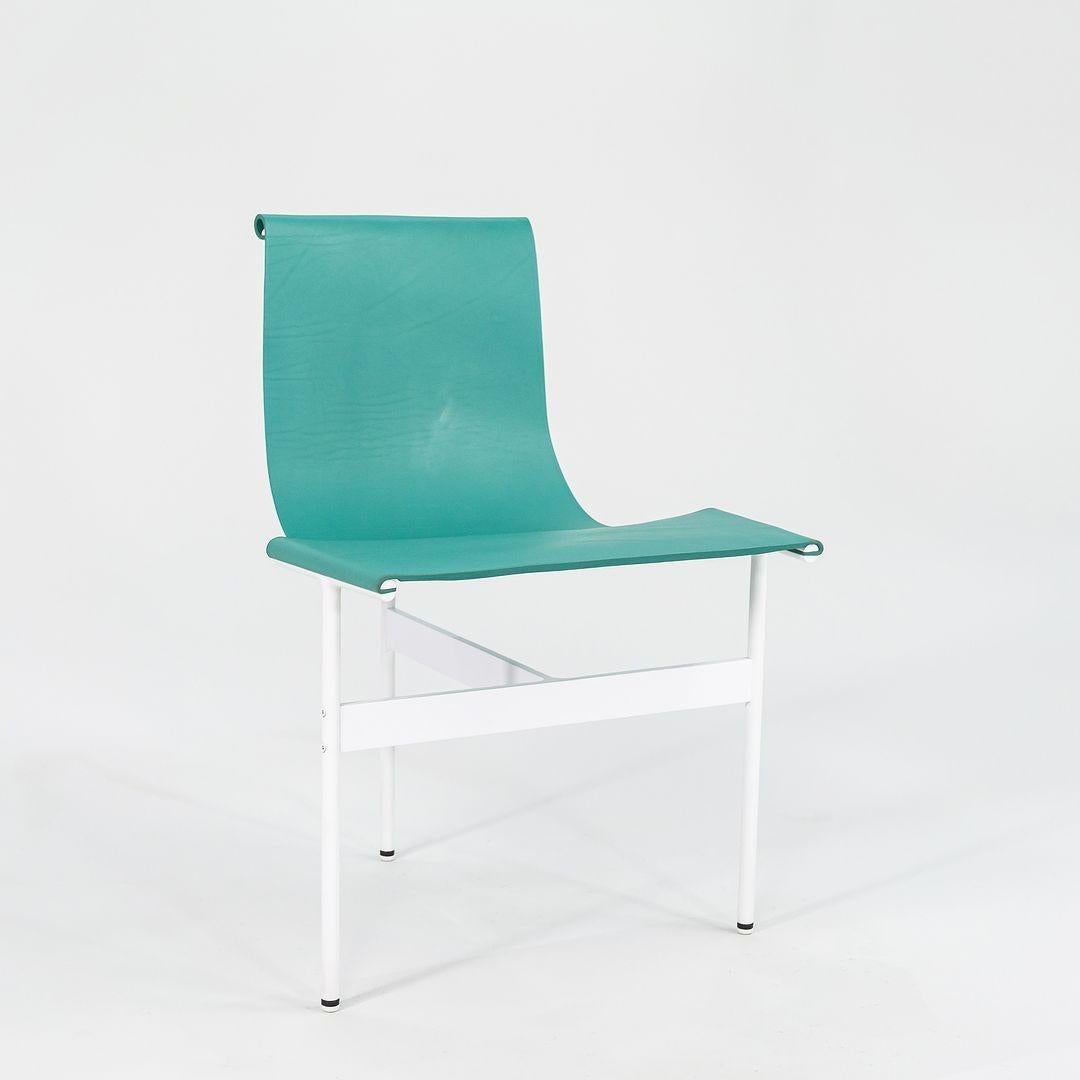 This is a pair of 2 (two) TG-10 sling dining chairs in turquoise leather with a white powder coat frame, produced by Gratz Industries. The chairs were designed by Katavolos, Littell and Kelley in 1952 as part of the original Laverne Collection