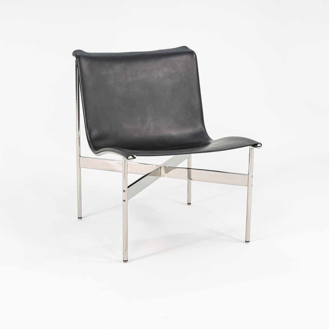 This is a TG-12 sling lounge chair in black leather with a polished chrome frame and t-bar, produced by Gratz Industries. The chair was designed in the 1950s by Katavolos, Littell and Kelley, distributed by Erwine and Estelle Laverne's International