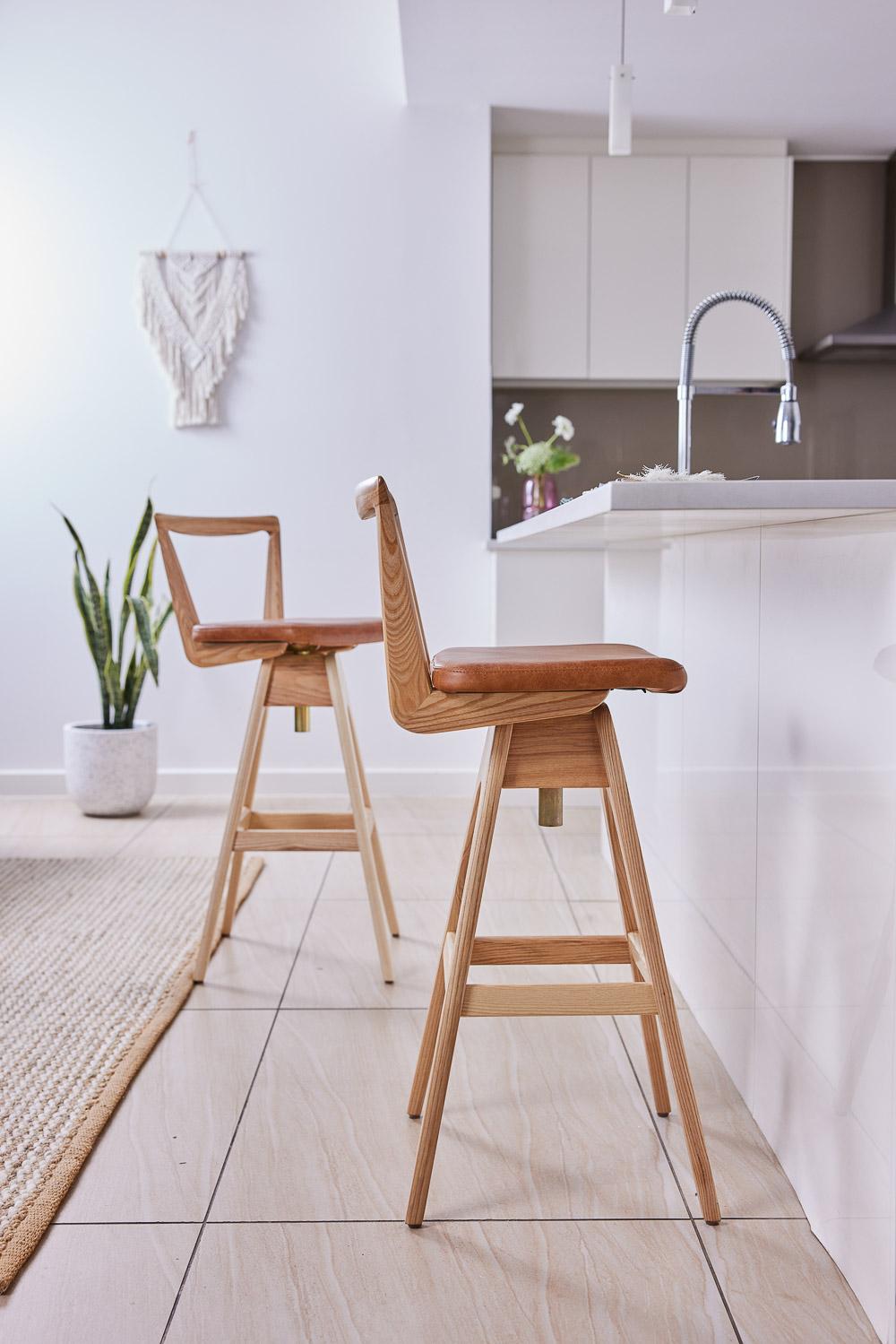 The TH Brown Danish bar stool was designed by Peter Brown and first manufactured from early 1960, and remains an iconic, timeless Australian design masterpiece to this day. The beautifully sculpted timber seat back, angled legs and hand stitched