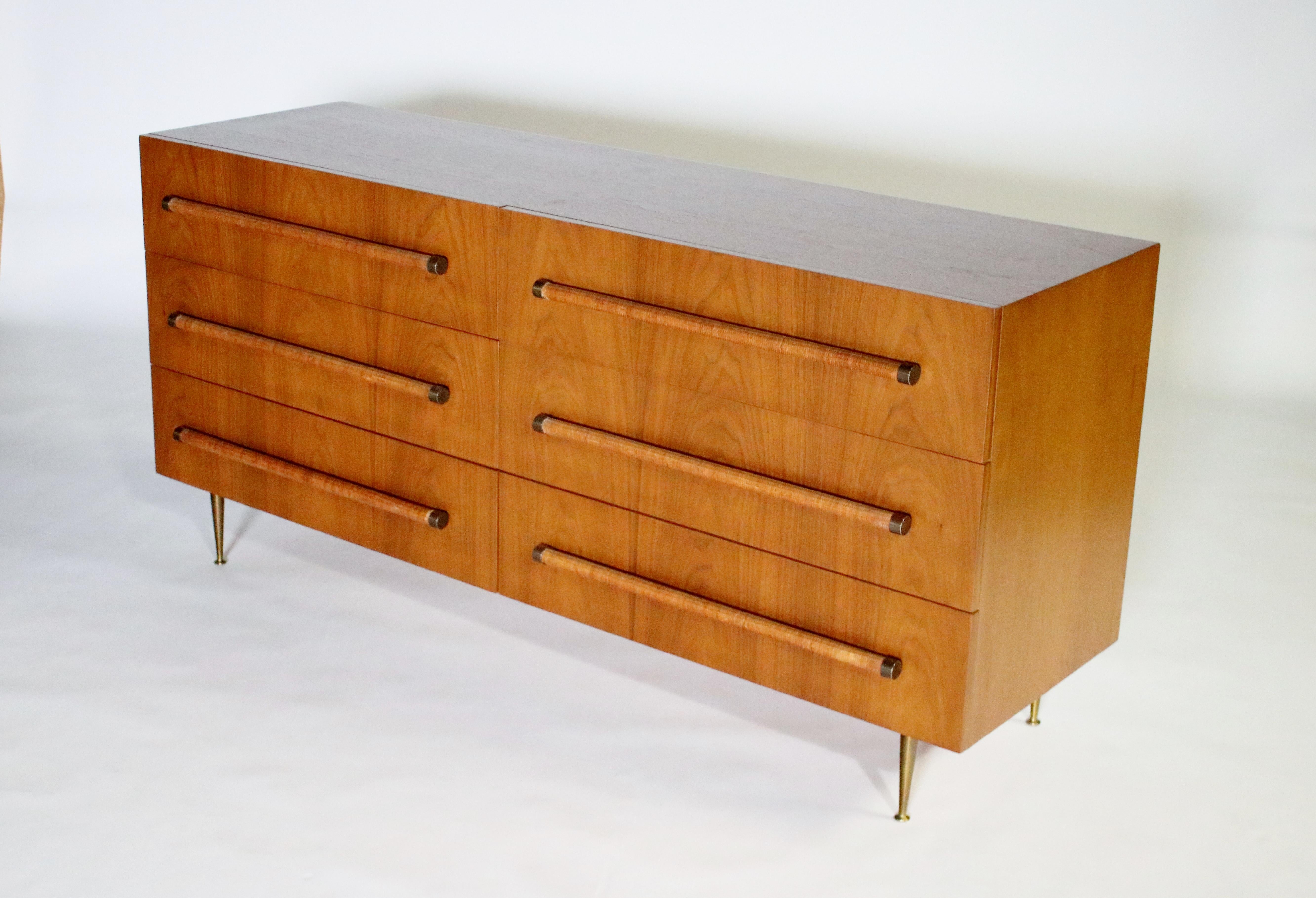 6-drawer dresser designed by T.H. Robsjohn Gibbiings for Widdicomb in beautifully restored walnut with all original brass legs, hardware and rattan pulls. Interior drawers include factory compartment interchangeable organizers and pull-out trays.