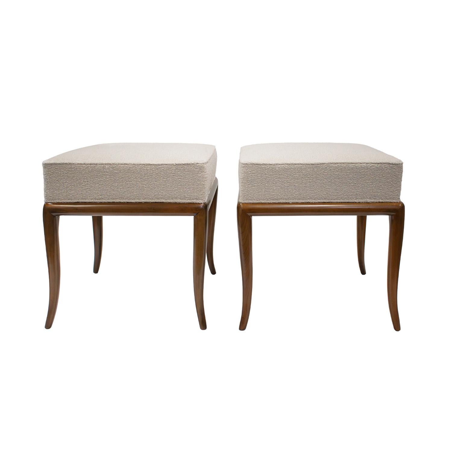 Pair of rare and elegant benches in walnut with iconic curved legs and upholstered seats by T.H. Robsjohn-Gibbings for Widdicomb, American 1950's. These benches are the epidemy of refined.  Bases have been newly refinished by Lobel Modern.  Seats