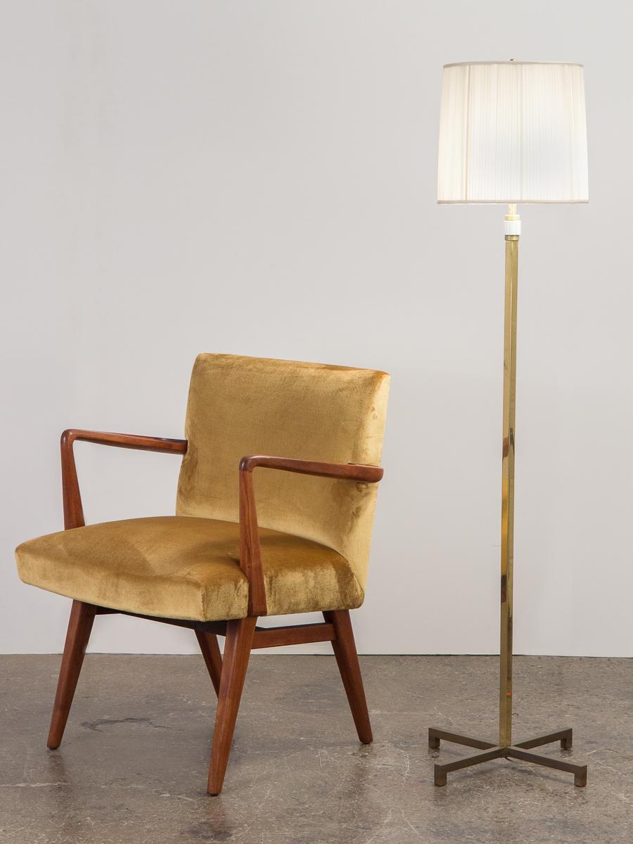 Beautiful brass floor lamp designed by T.H. Robsjohn-Gibbings for Hansen floor lamp. Solid, cross-shaped base compliments its squared brass pole. A clever, integrated celluloid switch at the pole functions to light the lamp. Includes original silk
