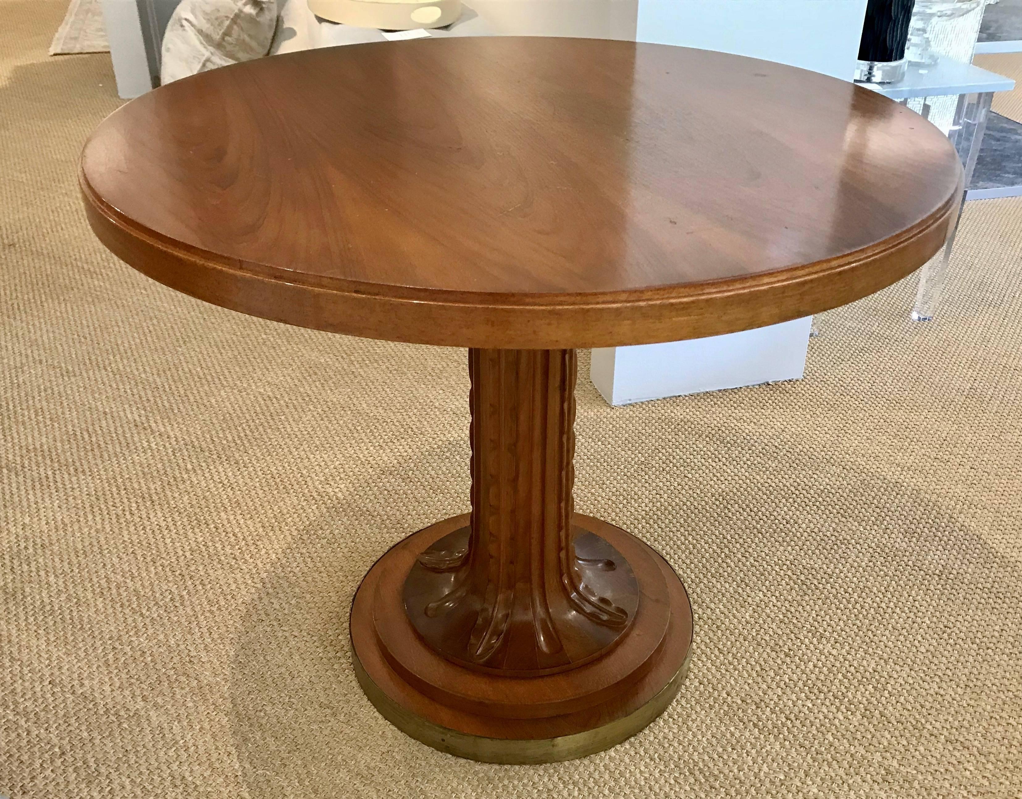 Round centre or hall table designed by T. H. Robsjohn-Gibbings for Saridis of Athens. Constructed of Greek walnut, this pedestal table returns to the ancient Grecian furniture designs of Gibbings most important commission, Casa Encantada. Stylized