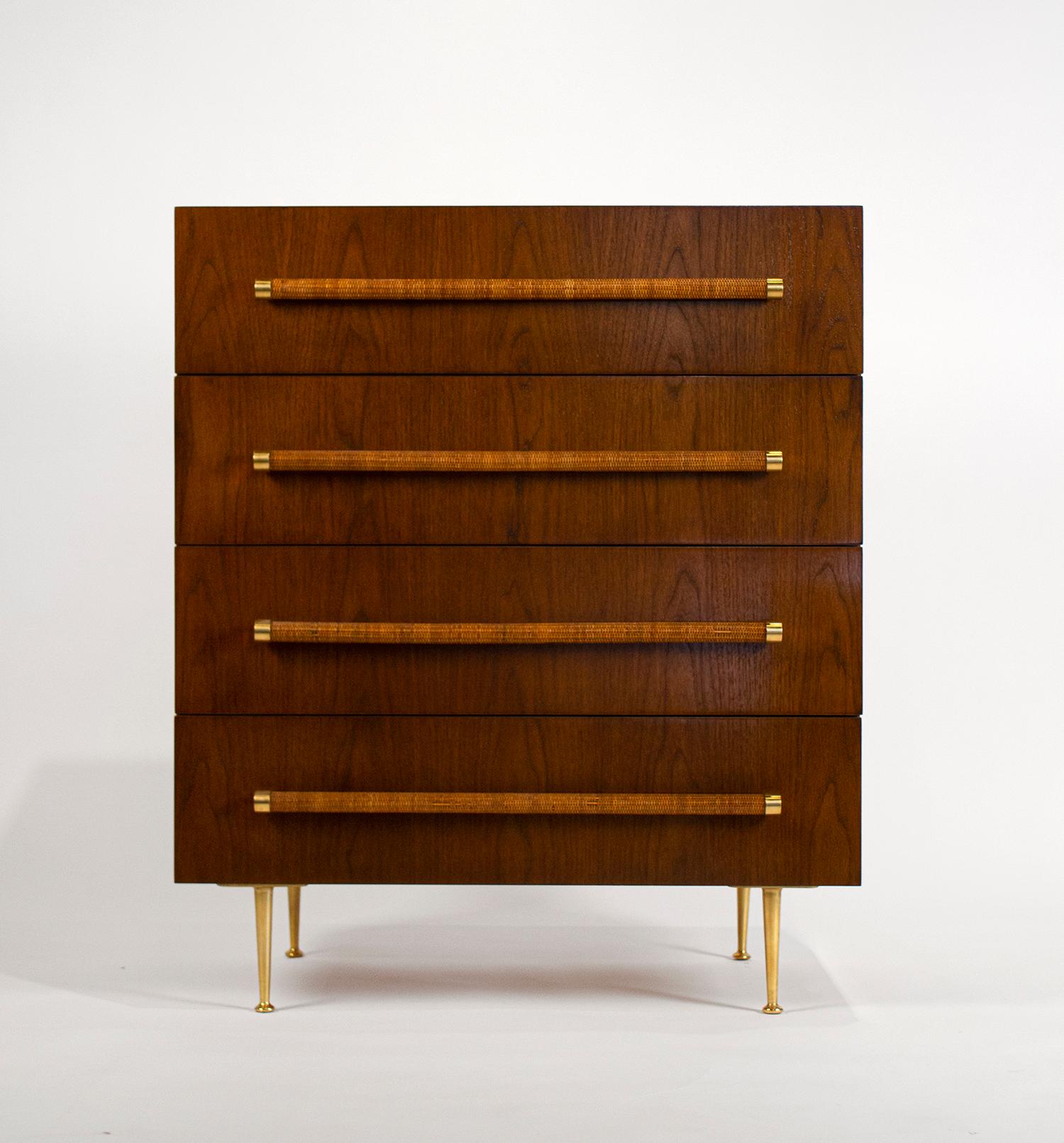 Bookmatched walnut chest of drawers with segmented oak interiors, woven cane wrapped handles, and solid polished brass hardware and feet. Signed with the Widdicomb label to the top drawers.