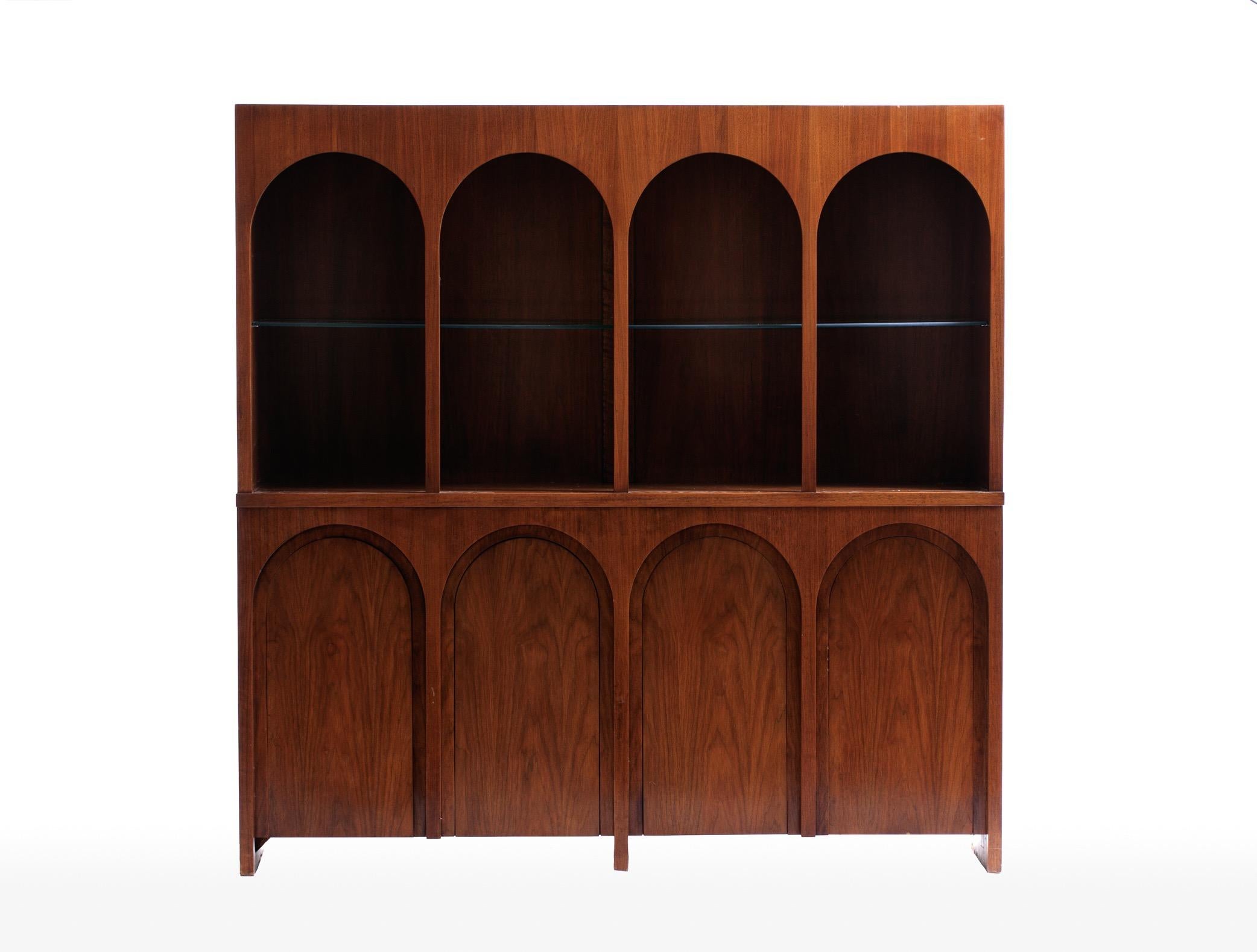 Coliseum cabinet designed by T. H. Robsjohng-Gibbings for Widdicomb. Architectural display cabinet with illuminated interior, adjustable glass shelves, the cabinet doors echo the design of a coliseum. Price included refinishing. Widdicomb label in