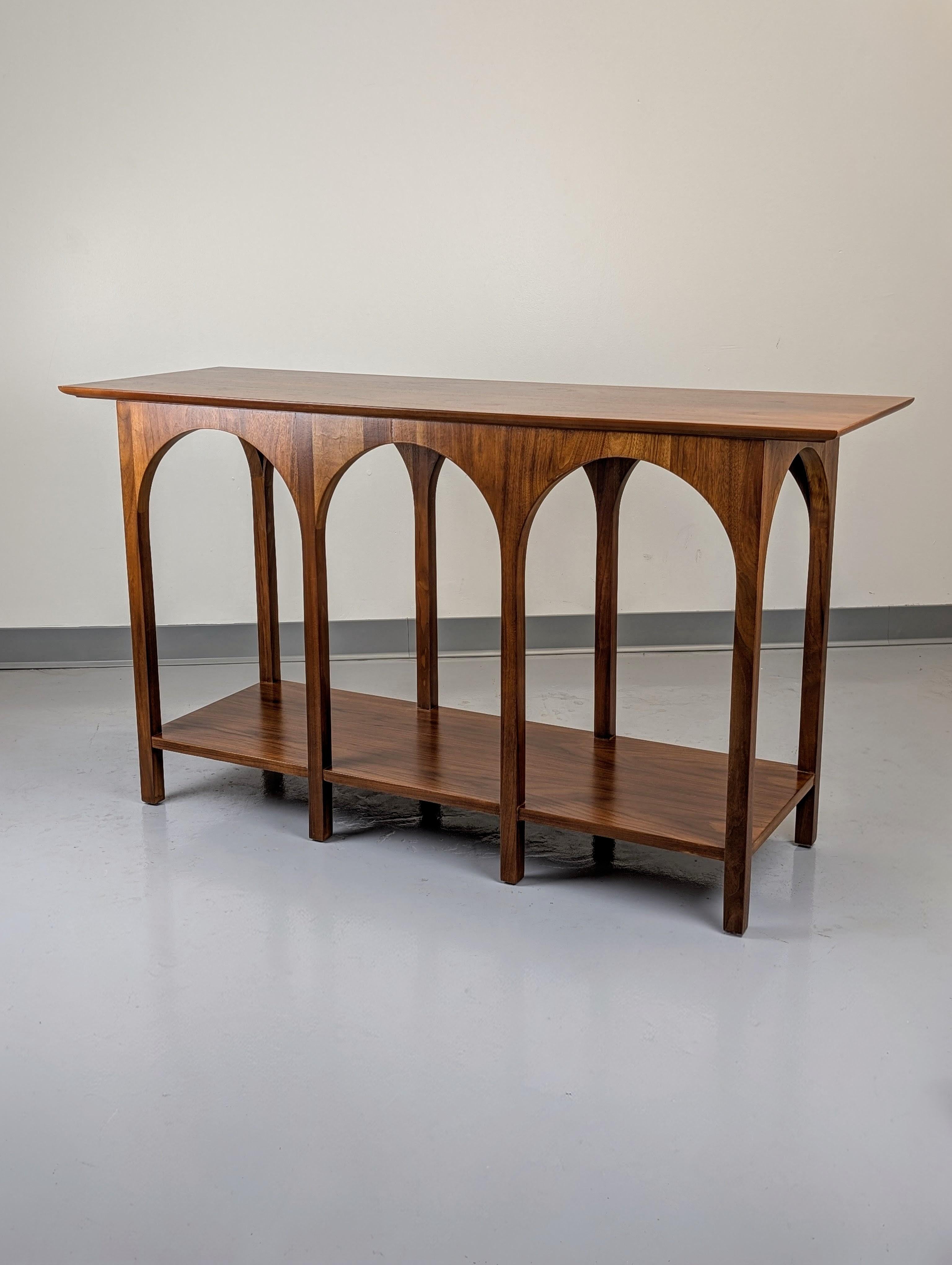 Rare Colosseum Console table designed by T.H. Robsjohn-Gibbings for Widdicomb. Cataloged as Model 3360 in Walnut. Striking grains. Labeled underneath. 