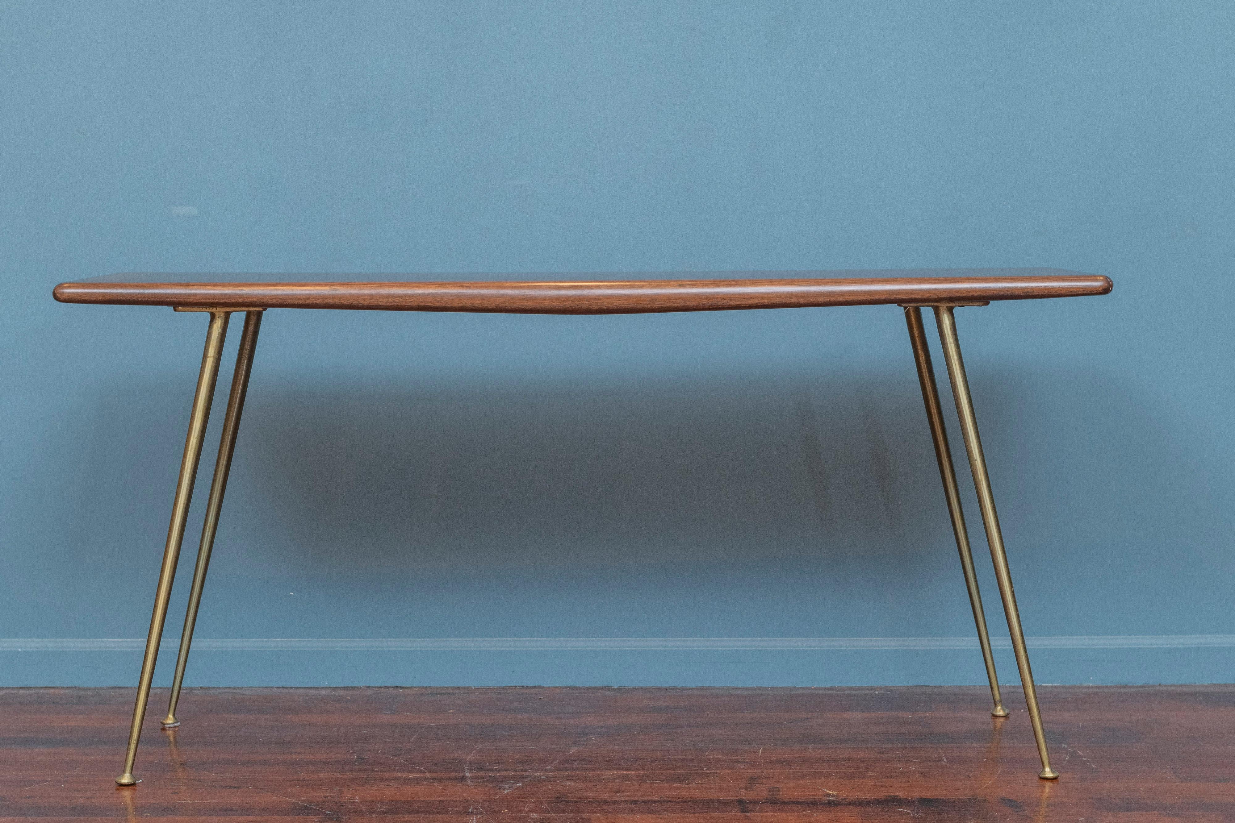 T.H. Robsjohn-Gibbings design console table for Widdicomb Furniture U.S.A. Beautiful contoured bull nose edges throughout on telescoping solid brass legs. Rare form table from his limited production line for Widdicomb, labeled.