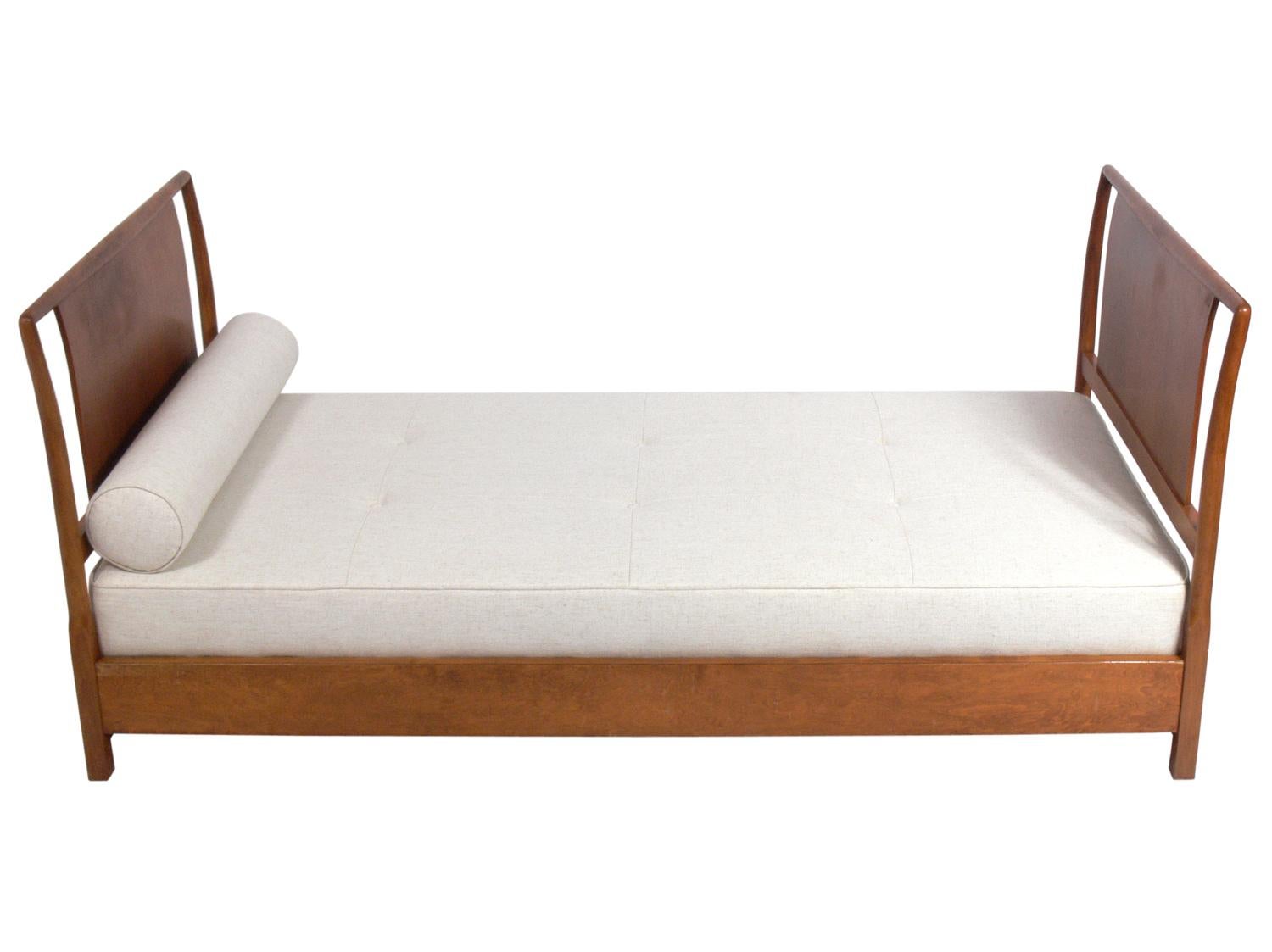 Elegant daybed, designed by T.H. Robsjohn-Gibbings for Widdicomb, American, circa 1950s. This daybed is currently being refinished and can be completed in your choice of color. The price noted below includes refinishing. It has been reupholstered in