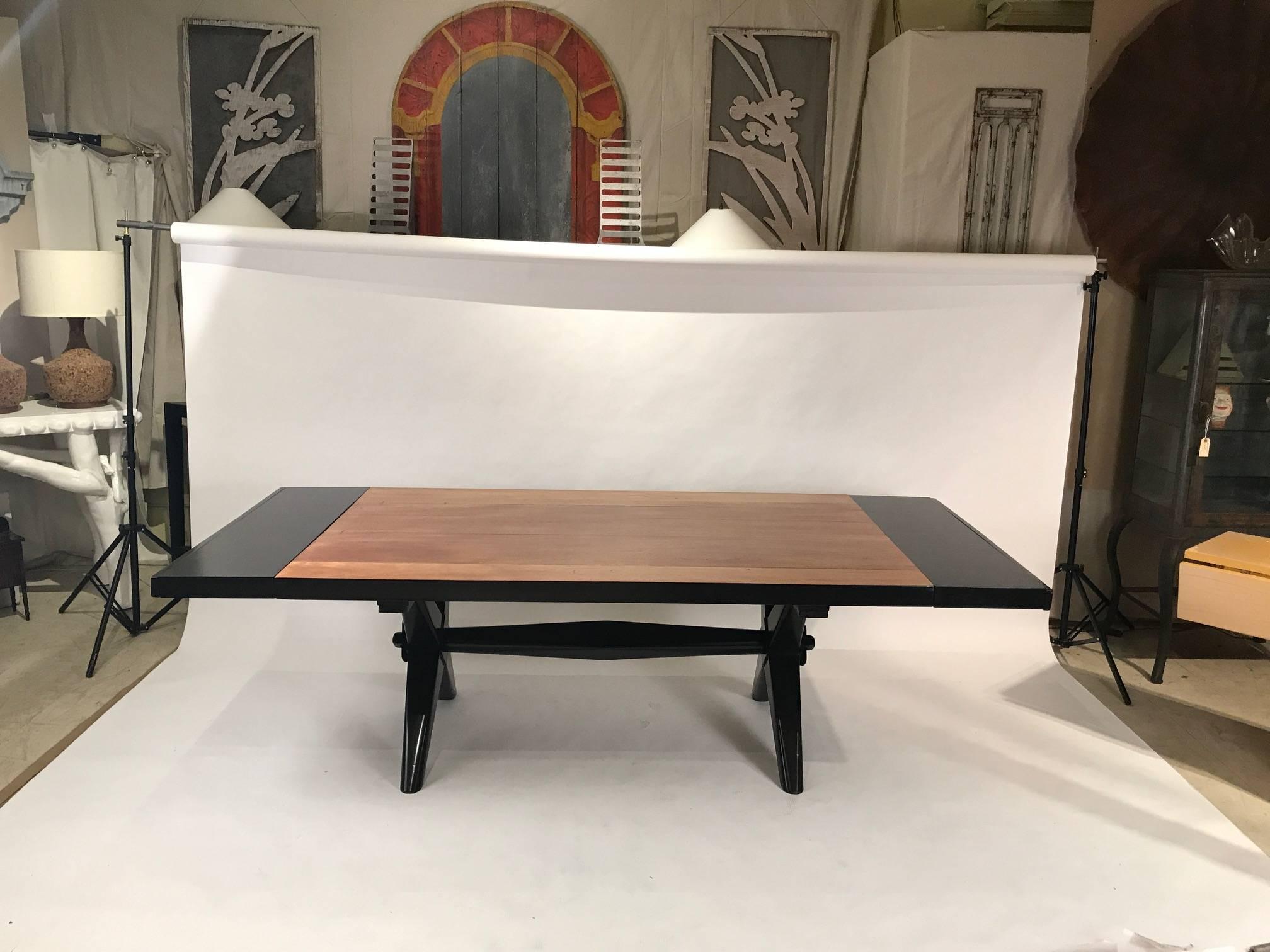 Manufactured by Widdicomb in the 1950s this beautiful Robsjohn-Gibbings table has a bleached mahogany top and the addition of two black lacquered extensions (see 2nd photo)
The 