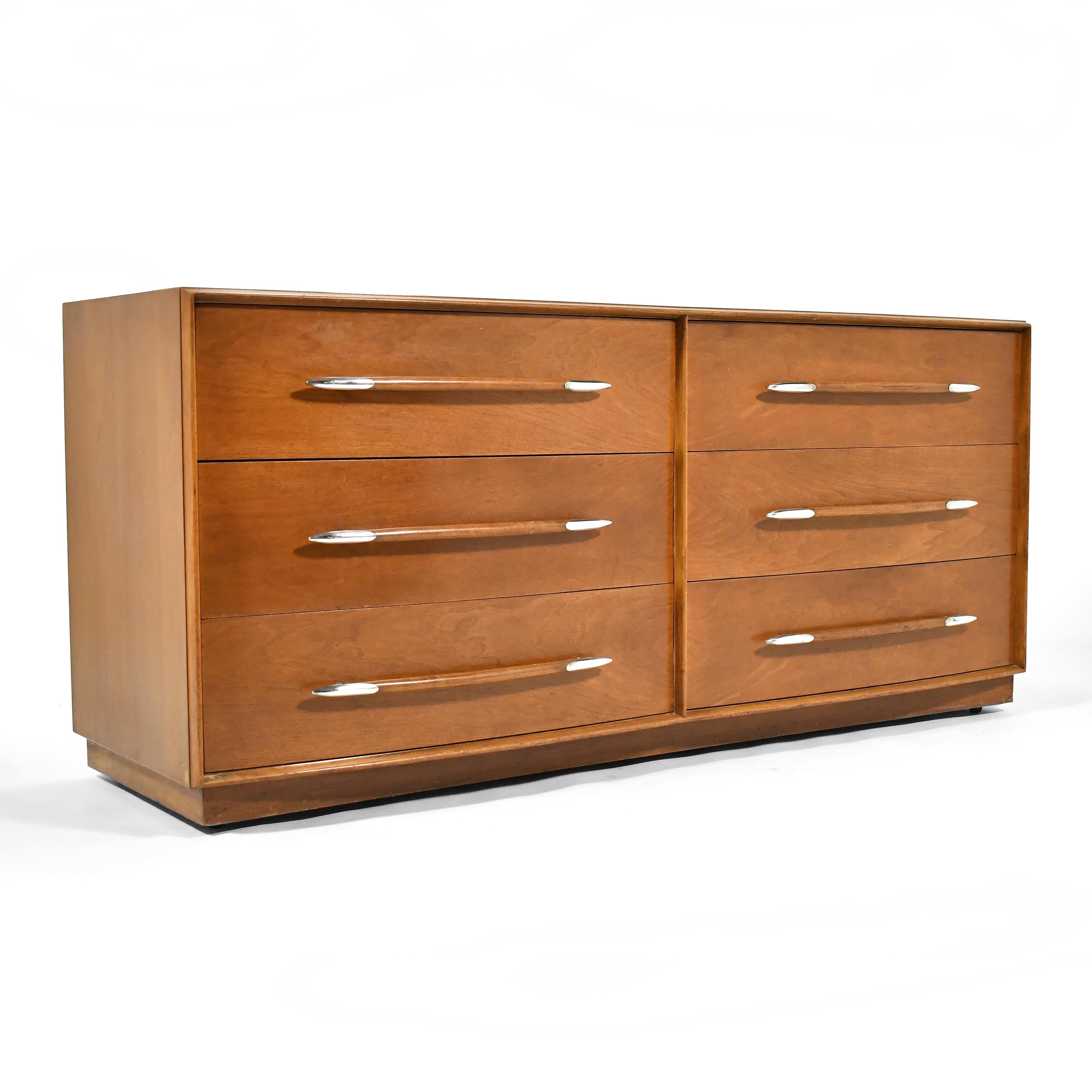 This stunning double dresser by T.H. Robsjohn-Gibbings for Widdicomb is impeccably designed and expertly crafted. The walnut case has is exquisitely detailed with the curved front and elegant spear-shaped silver pulls.

30