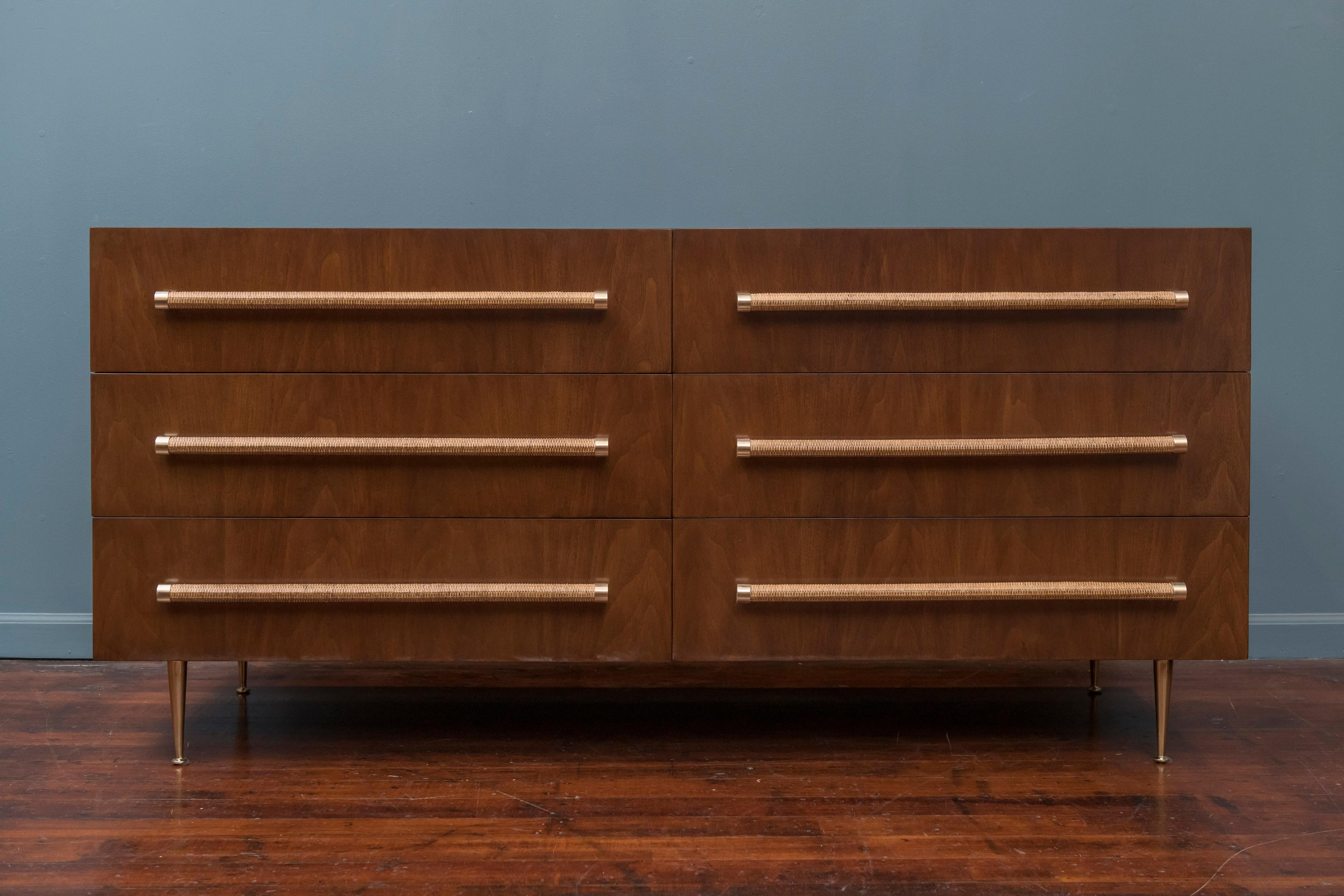 T.H. Robsjohn-Gibbings design six-drawer dresser for Widdicomb. Newly wrapped cane pulls, polished brass legs and perfectly refinished in medium walnut.