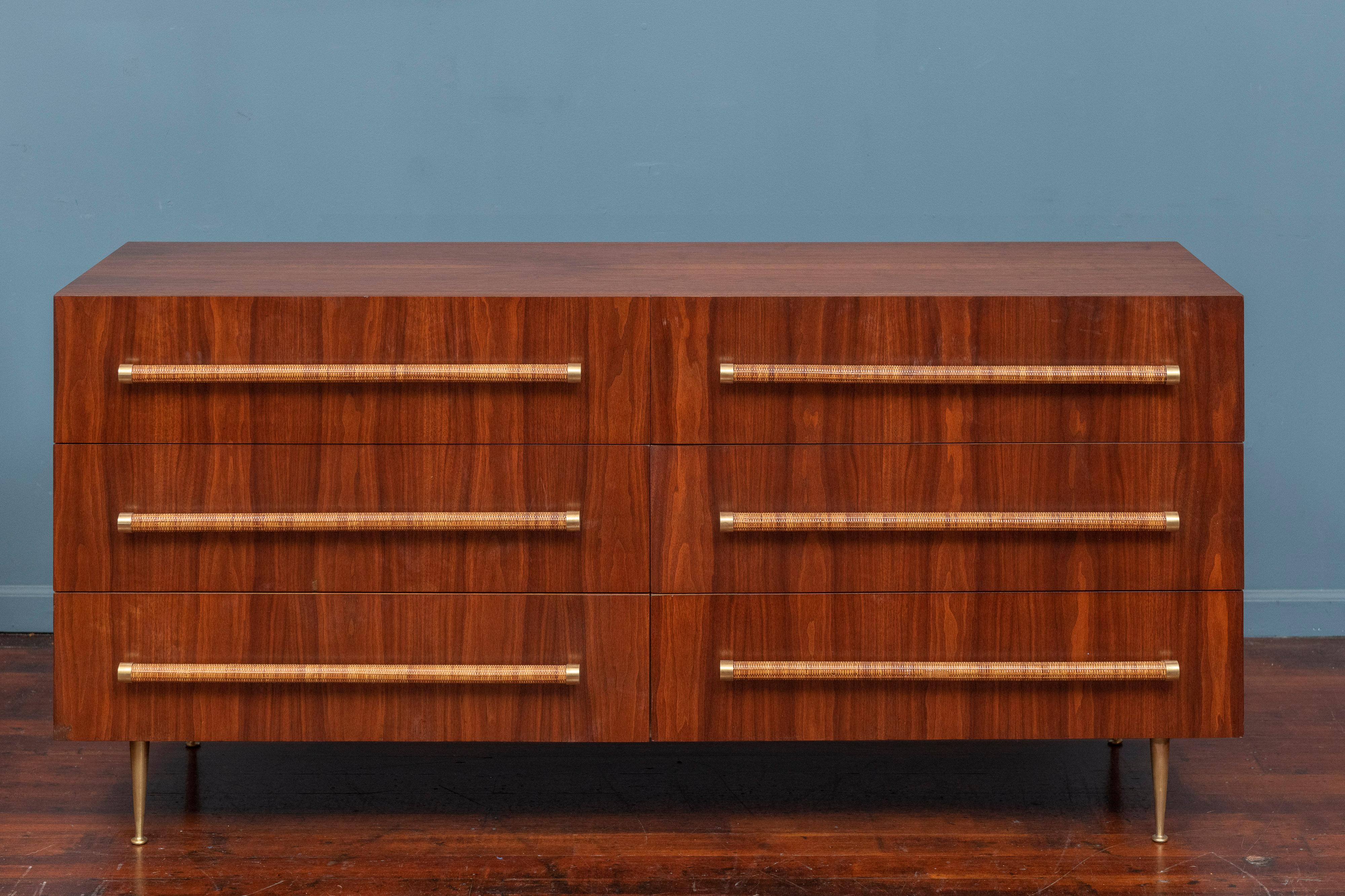 T.H. Robsjohn-Gibbings design dresser for Widdicomb, U.S.A. High quality construction using a figurative walnut veneered exterior and solid oak drawers with cane wrapped pulls on solid brass legs. All six drawers open and close smoothly and are