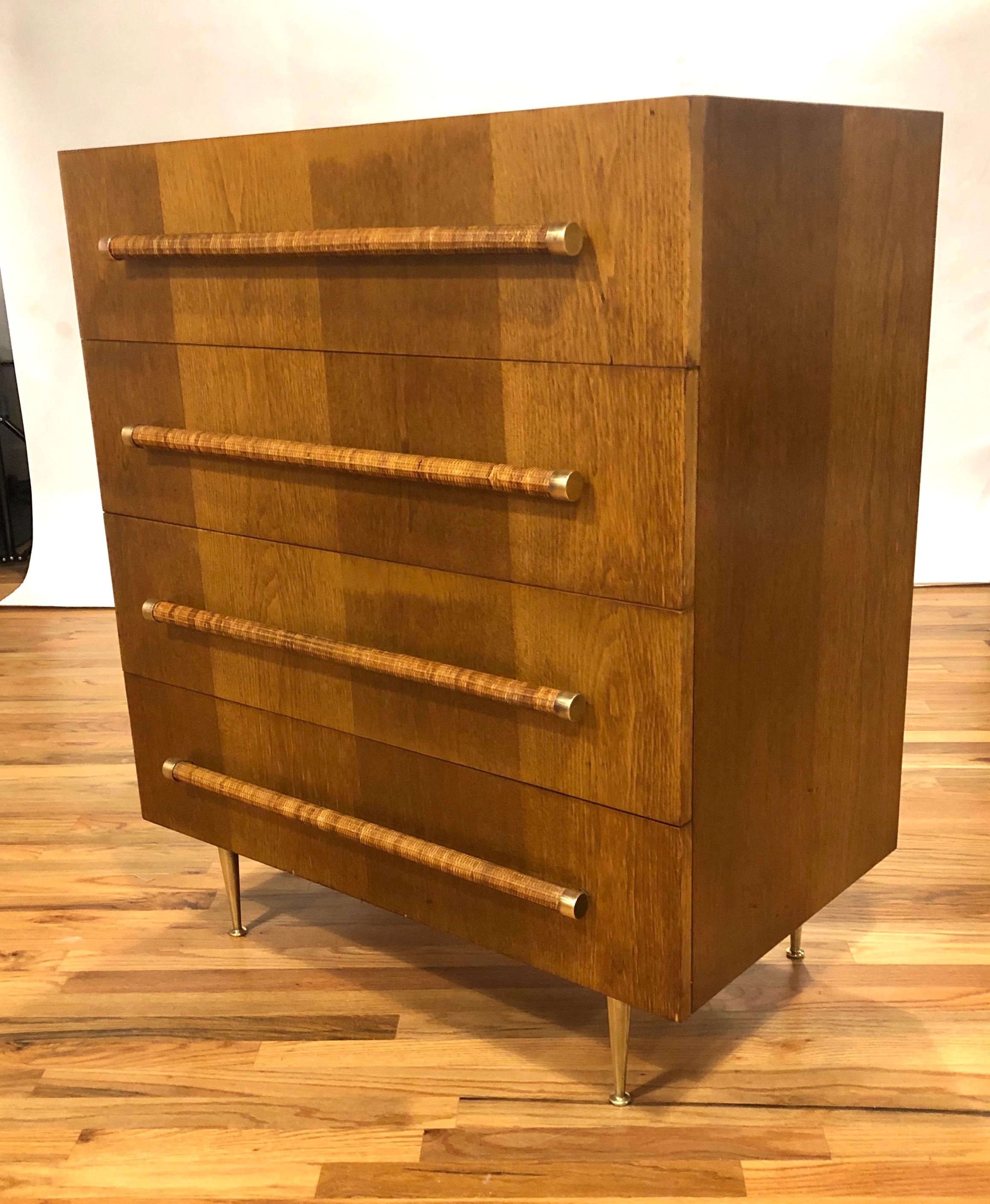 Original chest of drawers in walnut with reed handles and brass accents designed buy T.H. Robsjohn Gibbings for Widdicomb. The wood and reed have been lightly restored and the brass accents and legs have been hand polished. This elegant and iconic