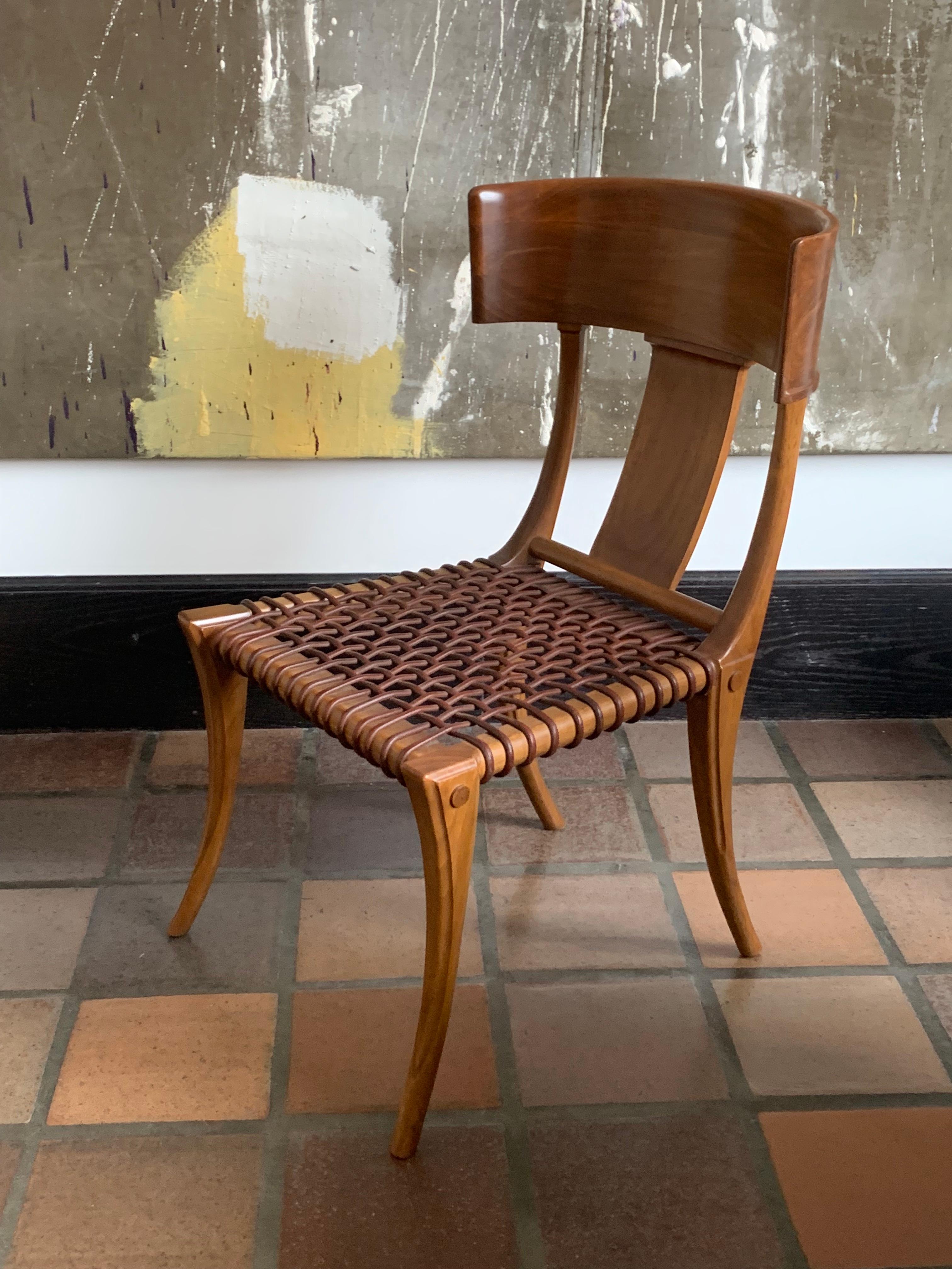 Single T.H. Robsjohn-Gibbings Klismos chair for Saridis of Athens, Greece in Greek walnut and leather woven seats. 

This chair was part of the collection he designed for Saridis of Athens in 1961, inspired by the drawings he saw on ancient Greek