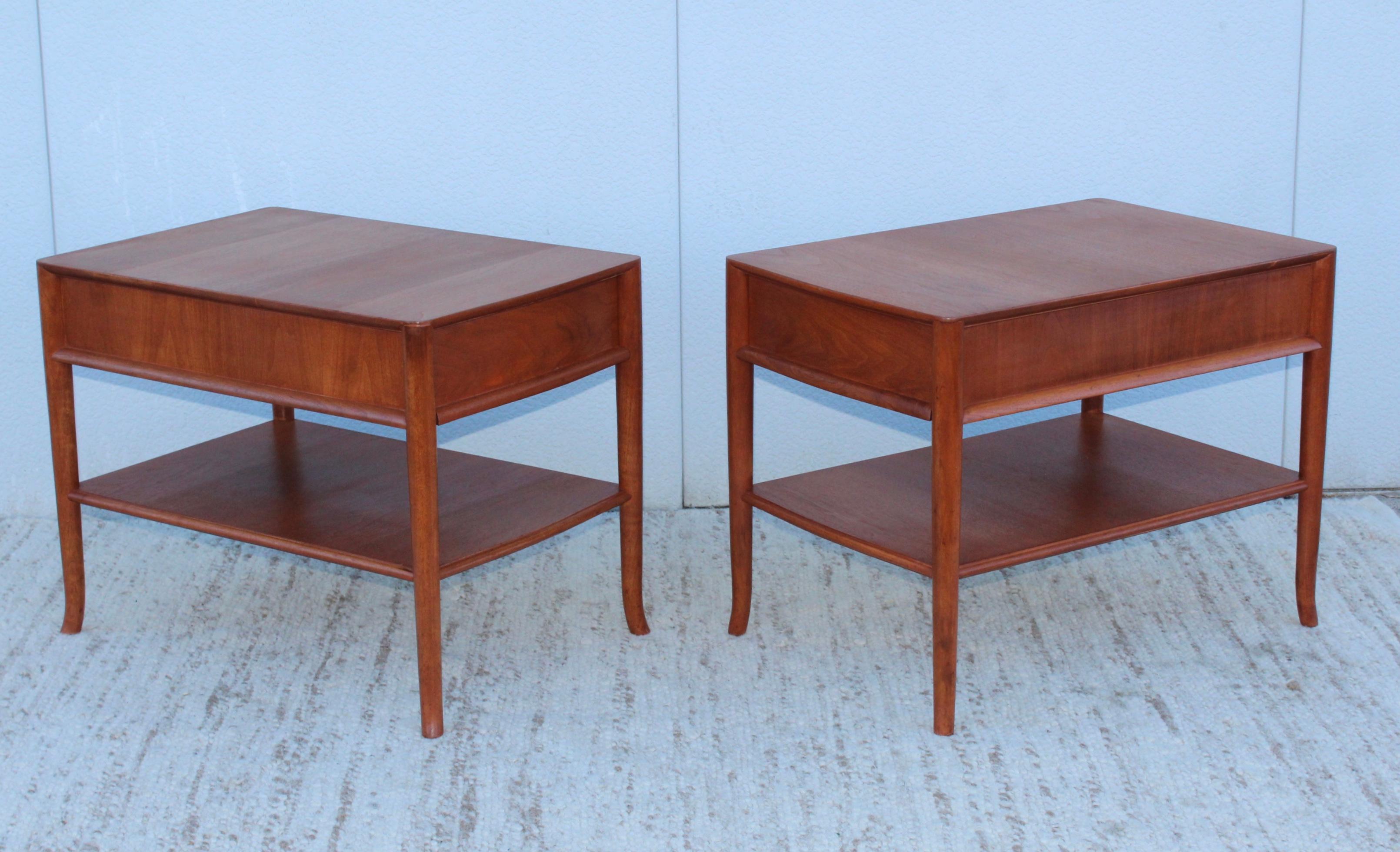 Rare pair of 1950s T.H. Robsjohn-Gibbings for Widdicomb model 3342 bedside tables. Two tear with single drawer and sabre legs.