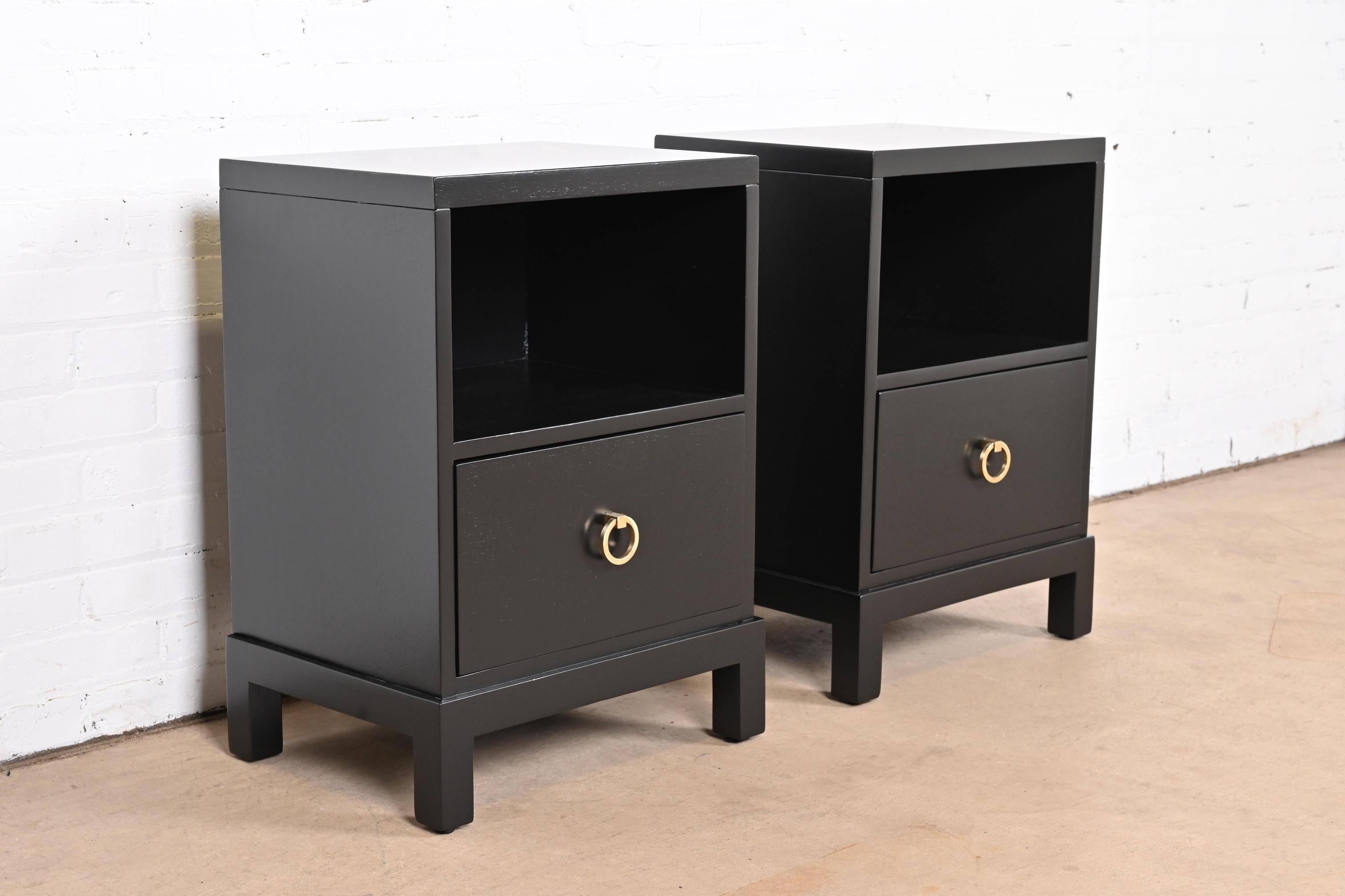 A gorgeous pair of Mid-Century Modern Hollywood Regency black lacquered nightstands

By T.H. Robsjohn-Gibbings for Widdicomb and retailed by John Stuart

USA, 1950s

Black lacquered walnut, with original brass hardware.

Measures: 18.75