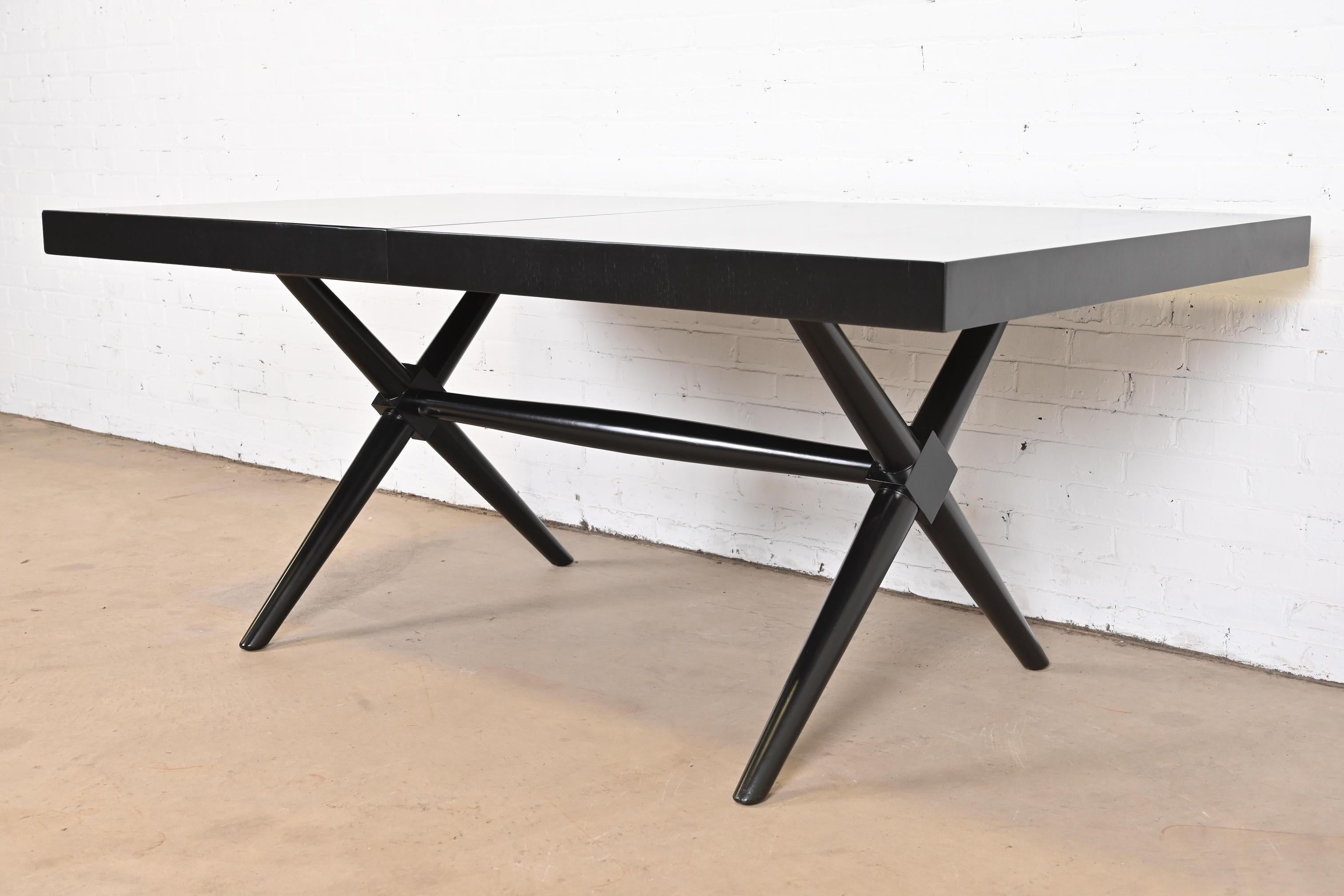 An exceptional Mid-Century Modern X-base extension dining table.

By T.H. Robsjohn-Gibbings for Widdicomb

USA, 1950s

Walnut, in black lacquered finish.

Measures: 72