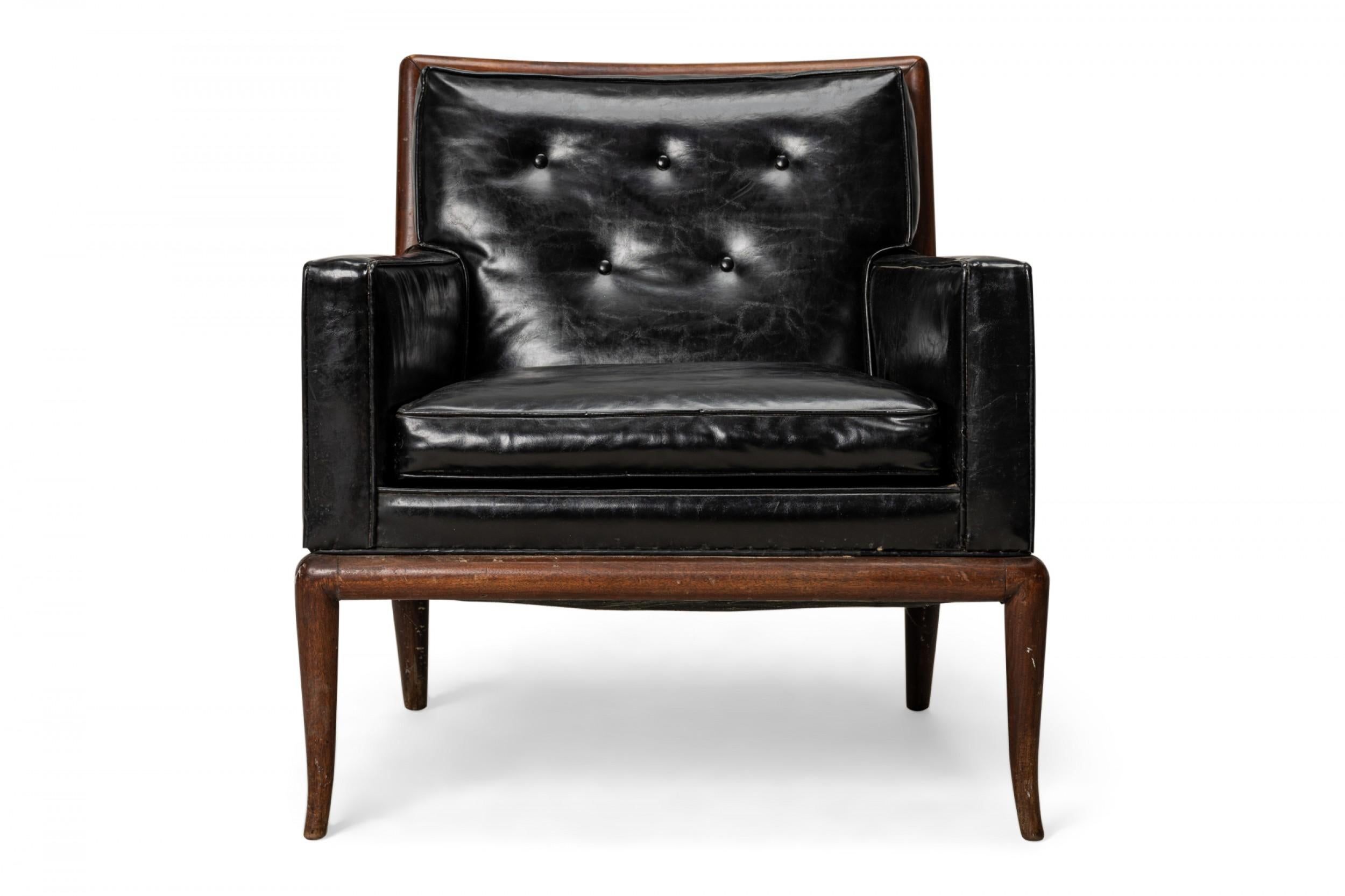 American mid-century lounge / armchair with a square walnut frame and black leather upholstery with a button tufted back, resting on four slightly curved and tapered walnut legs. (T.H. Robsjohn-Gibbings for Widdicomb Furniture Co.).
   