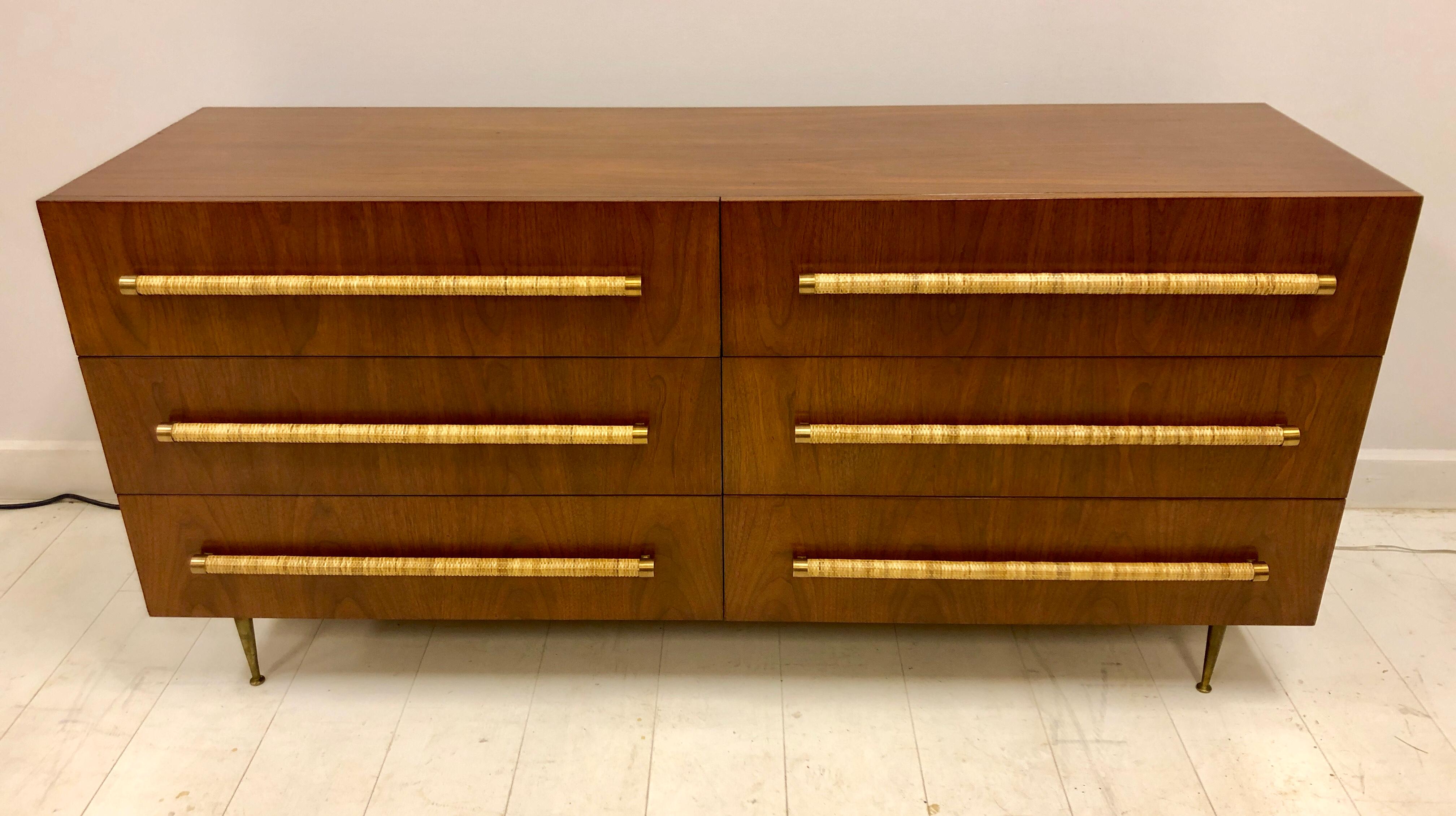 Classic T.H. Robsjohn-Gibbings for Widdicomb 6-drawer cabinet in beautiful original finish dark walnut, with brass legs, and raffia cane wrapped handles. Signed with remnants of cloth Widdicomb label.