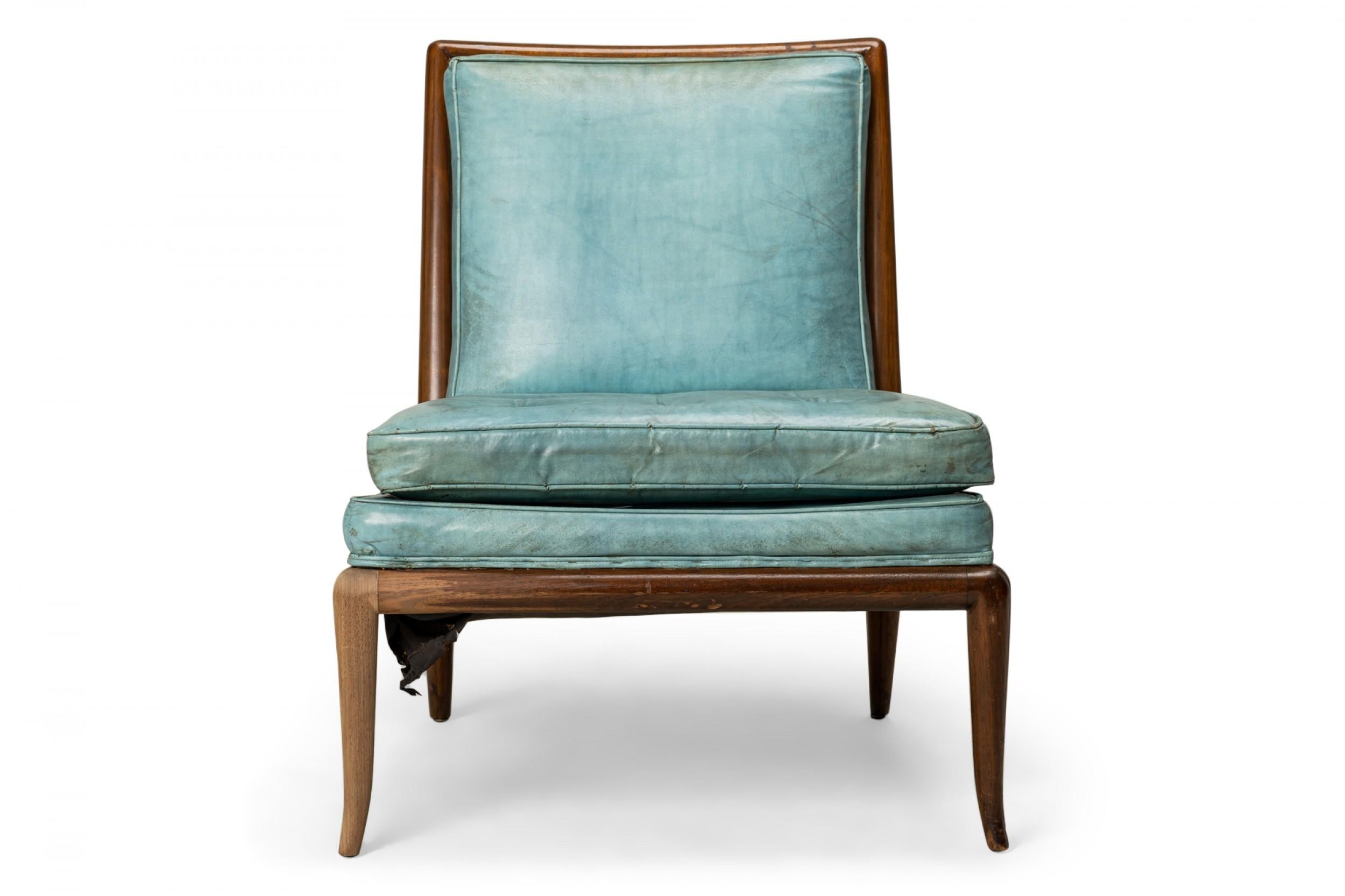 American Mid-Century slipper chair with a square walnut frame, upholstered in powder blue leather with a button-tufted seat cushion, resting on four gently curved and tapered legs. (T.H. ROBSJOHN-GIBBINGS FOR WIDDICOMB FURNITURE COMPANY)(Similar