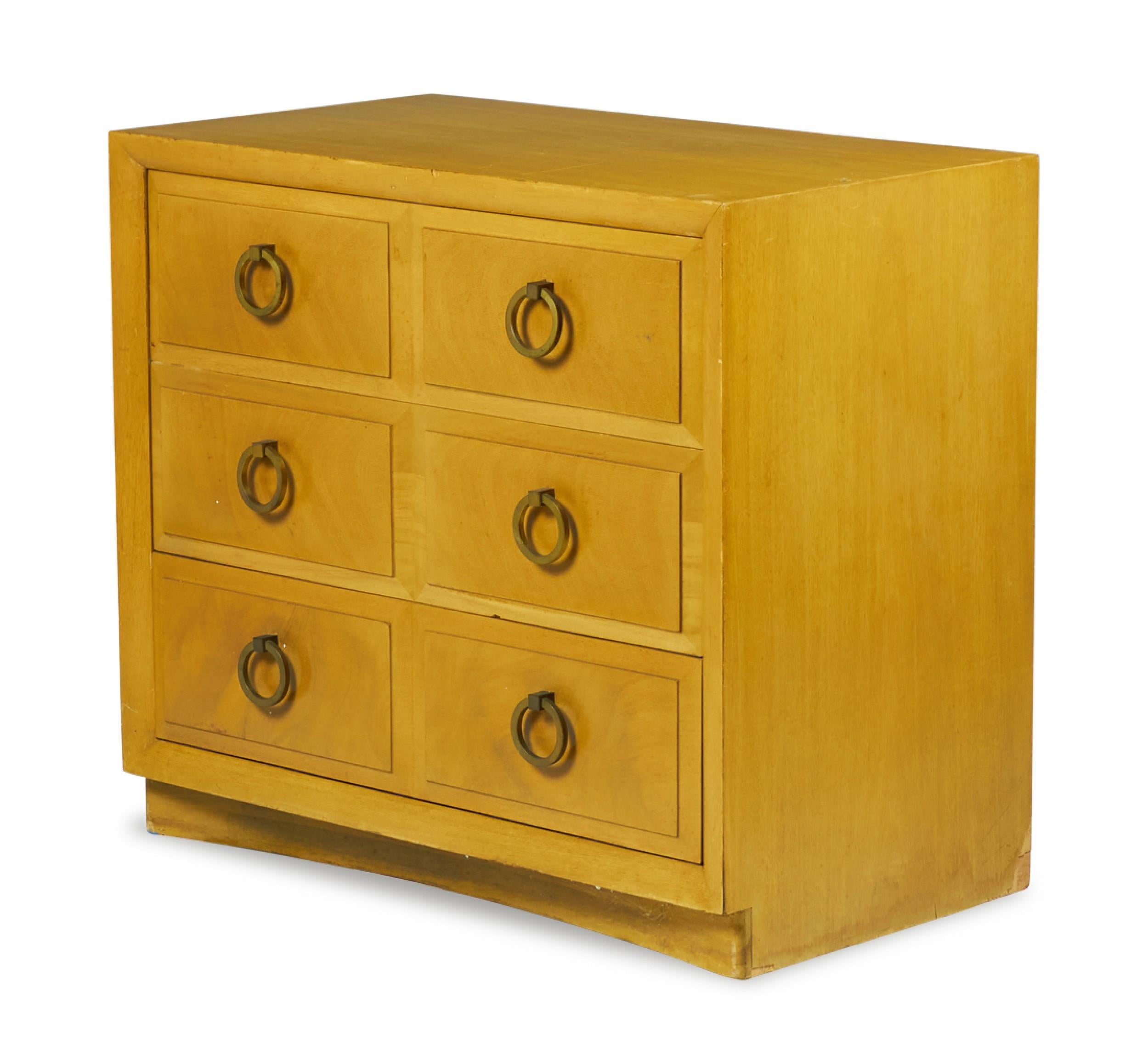 American mid-century (1950s) maple three-drawer chest with beveled drawer fronts and six brass ring-shaped drawer pulls. (T.H. ROBSJOHN-GIBBINGS FOR WIDDICOMB MODERN)
 