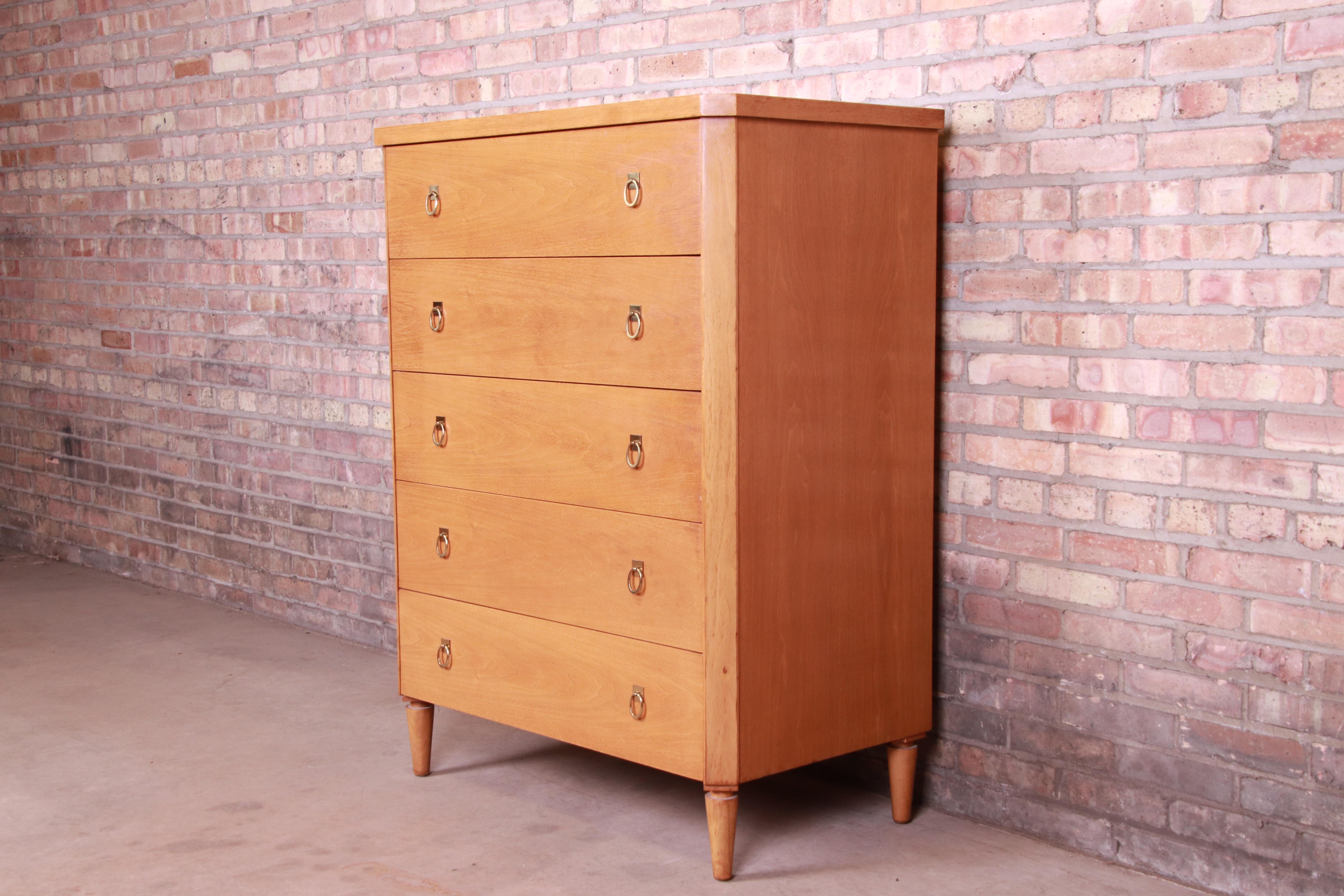 An exceptional Mid-Century Modern highboy dresser

By T.H. Robsjohn-Gibbings for Widdicomb

USA, 1950s

Walnut, with original brass hardware.

Measures: 36.38