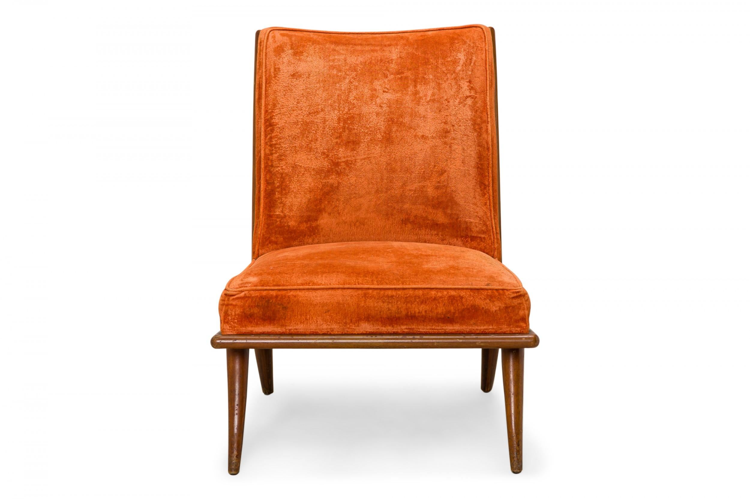 American Mid-Century slipper / side chair with a walnut frame, square profile, and orange velour upholstery, resting on four slightly tapered dowel legs. (T.H. ROBSJOHN-GIBBINGS FOR WIDDICOMB FURNITURE COMPANY)
