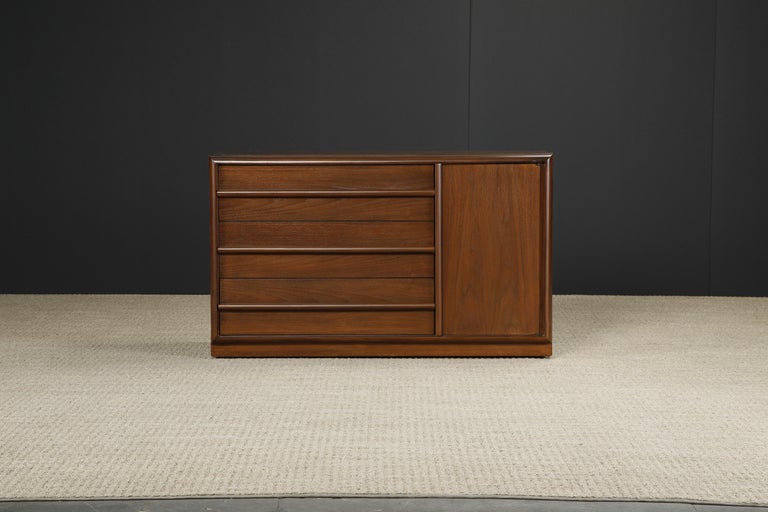 This elegant refinished dresser by T.H. Robsjohn-Gibbings for Widdicomb (USA) features gorgeous walnut grain with three drawers and one cabinet door, all with integrated pulls. Signed with Widdicomb label in one drawer. Refinished beautifully with a