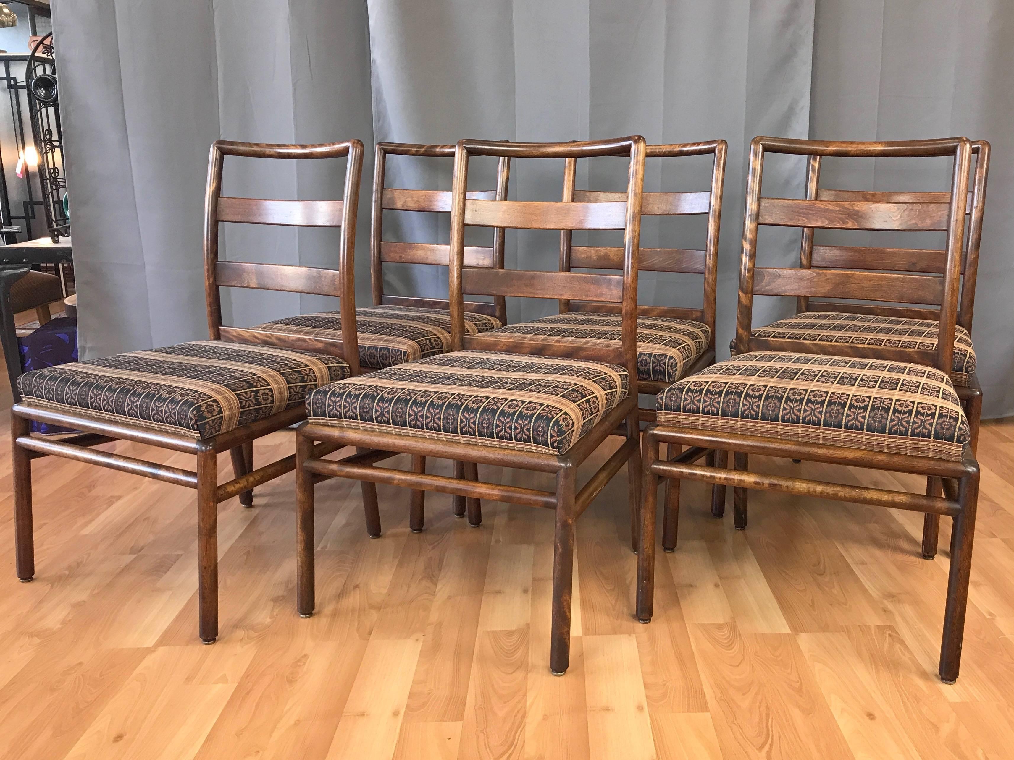 A six-piece set of very handsome midcentury ladder back dining chairs in maple by T.H. Robsjohn-Gibbings for Widdicomb Furniture Co.

Rounded and comfortable solid maple frame has a warm hickory stained finish that highlights the lively, shimmering