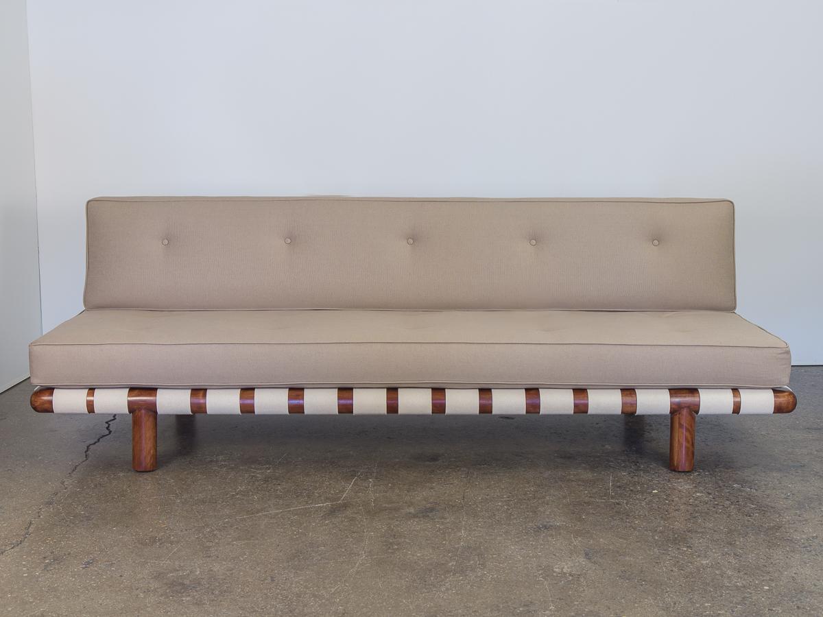 Incredibly rare T.H. Robsjohn-Gibbings sofa model 1711 for Widdicomb. Sofa may be delivered in customer ordered material. Freshly woven cotton webbing in a bright ivory hue compliments the bleached mahogany sculpted frame, which has been fully and