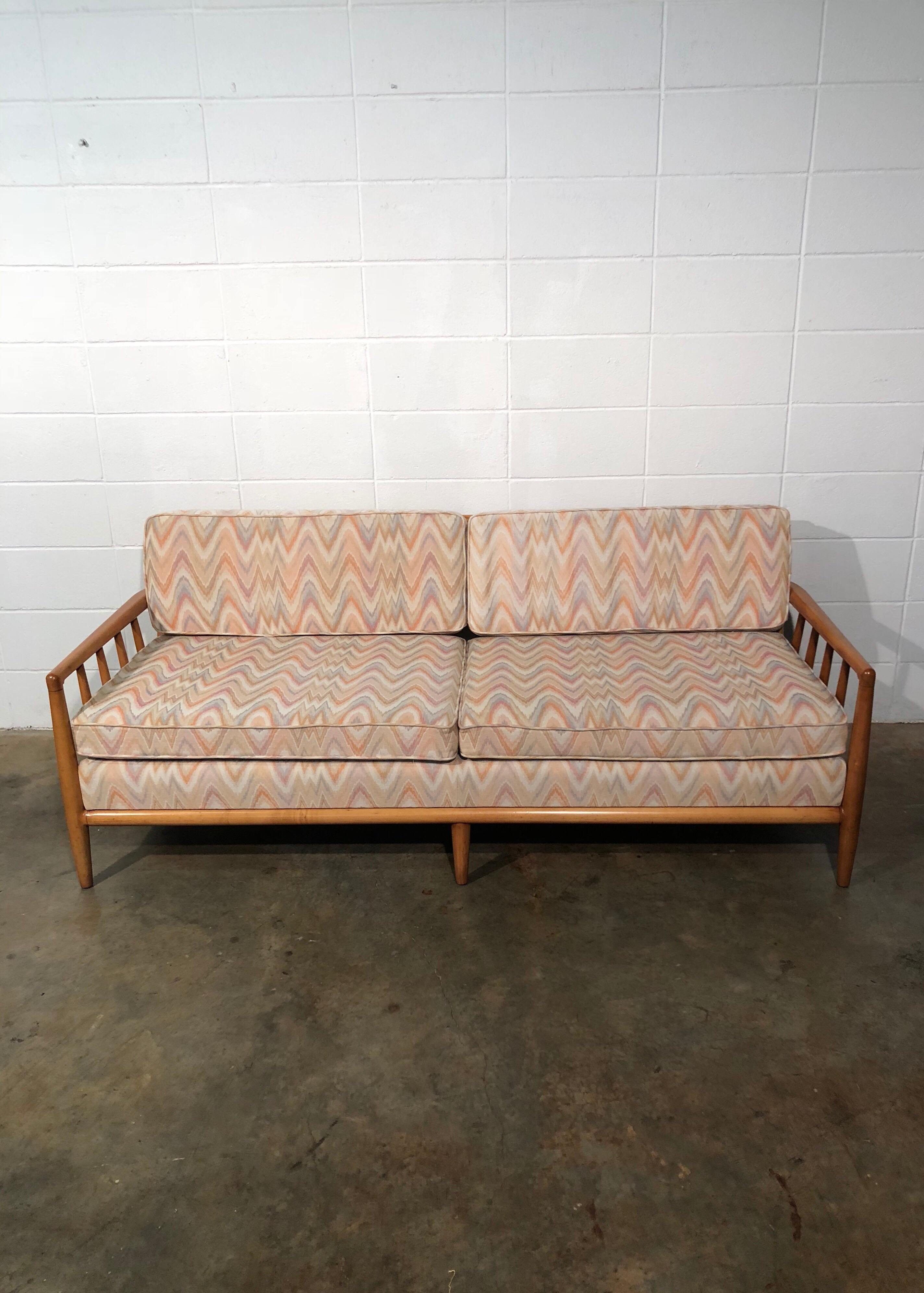 Mid-Century Modern spindled sofa in vintage flame stitch fabric. The sofa is in great original condition. It has been thoroughly cleaned and has no structural issues. Retains vintage upholstery in excellent condition. No known defects that would