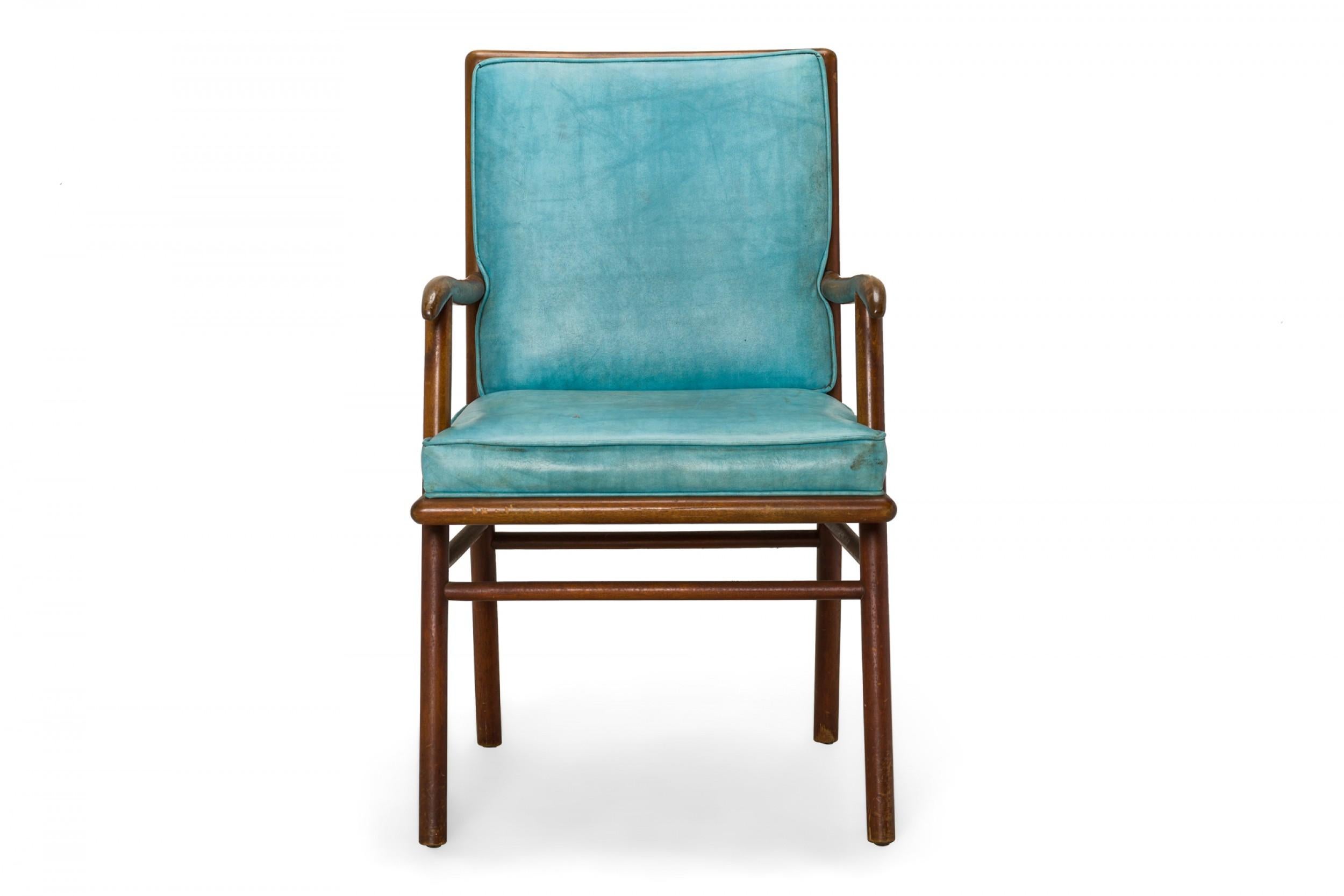 American Mid-Century dining armchair with a shaped walnut frame and bright blue vinyl upholstered seat and back cushions, resting on four angled dowel legs. (T.H. ROBSJOHN-GIBBINGS FOR WIDDICOMB FURNITURE COMPANY)
