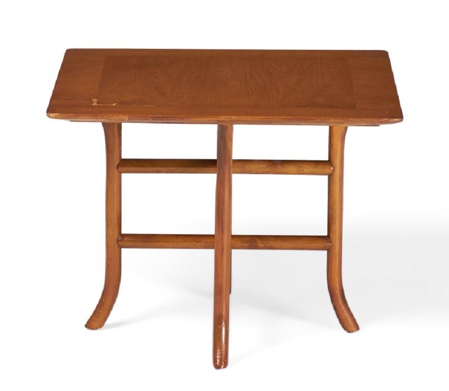 American Mid-Century (1950s) walnut occasional / side table with a square top supported by a crossed trestle base with curved sabre feet. (T.H. ROBSJOHN-GIBBINGS FOR WIDDICOMB FURNITURE)(Similar pieces with different finishes: