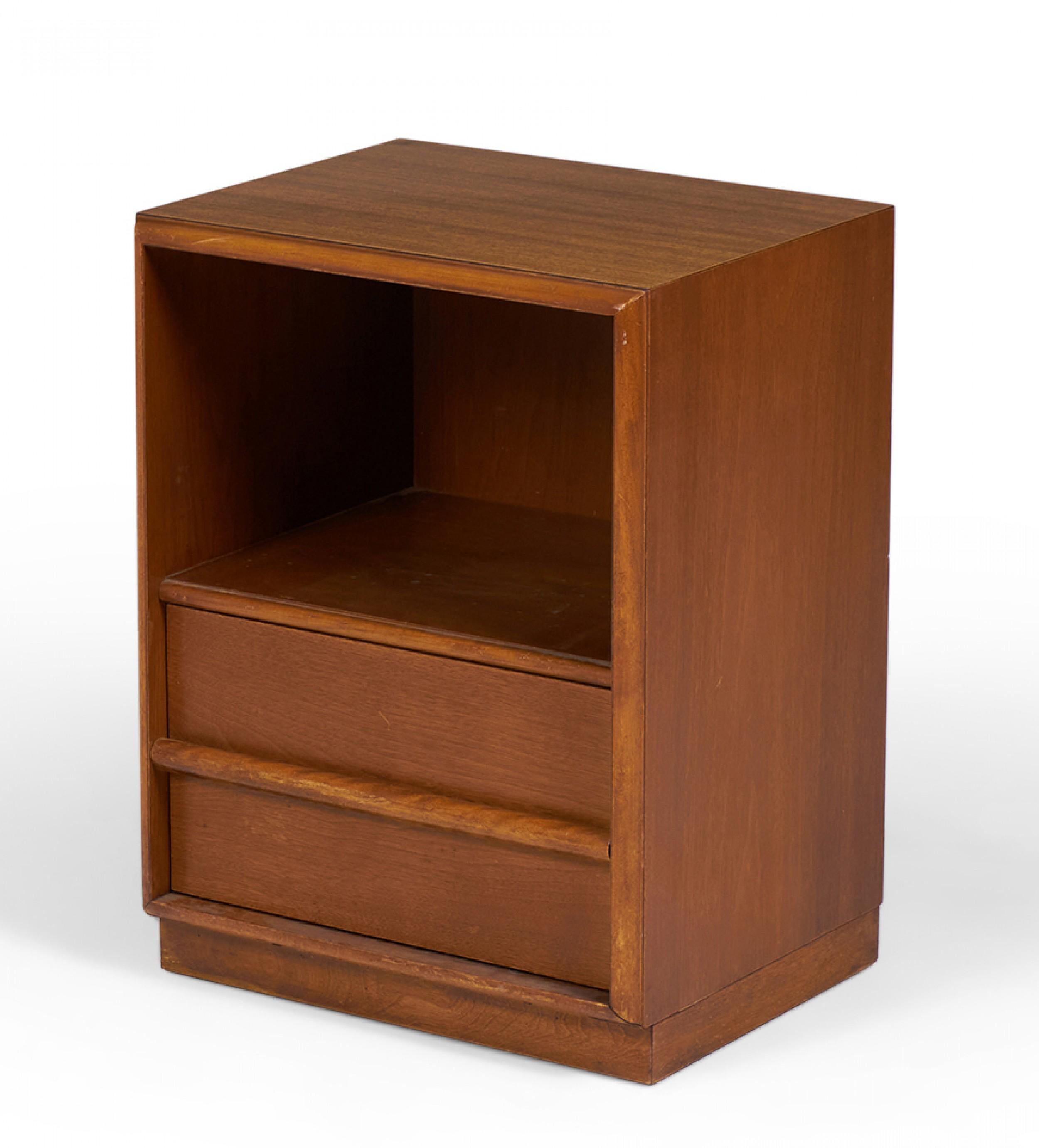 American Mid-Century walnut nightstand with an open upper cabinet shelf and a single lower drawer with a horizontal raised wooden drawer pull. (T.H. ROBSJOHN-GIBBINGS FOR WIDDICOMB)(Same piece with different finish: DUF0143A&B).