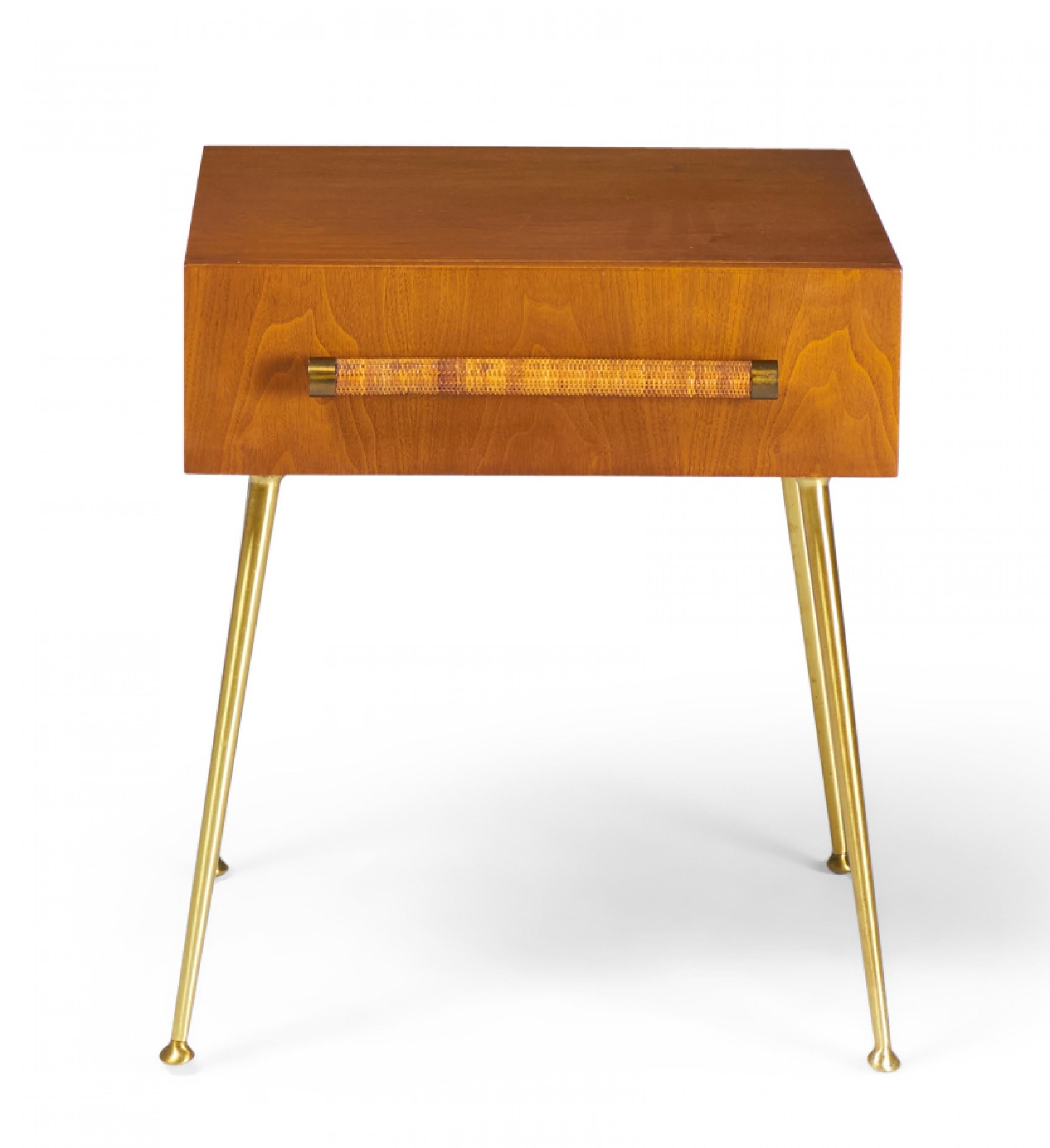 3 American mid-century (1950s) walnut single drawer nightstands with rattan-wrapped dowel drawer pulls and four tapered brass legs with circular brass feet. (T.H. Robsjohn-Gibbings for Widdicomb)(Priced each).