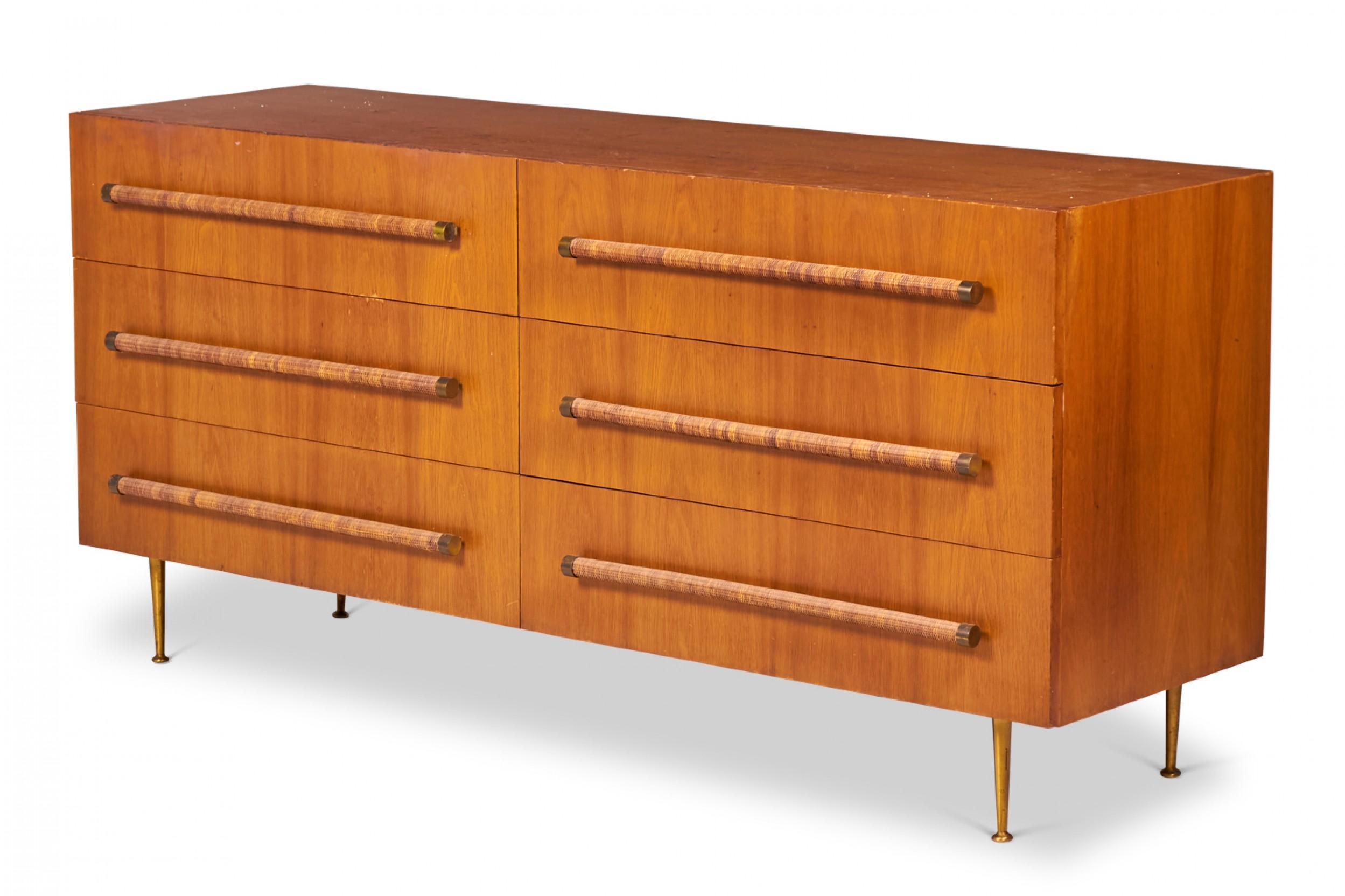 American mid-century (1950s) walnut six-drawer chest of drawers with rattan-wrapped dowel drawer pulls and four tapered brass legs with circular brass feet. (T.H. Robsjohn-gibbings for Widdicomb).
