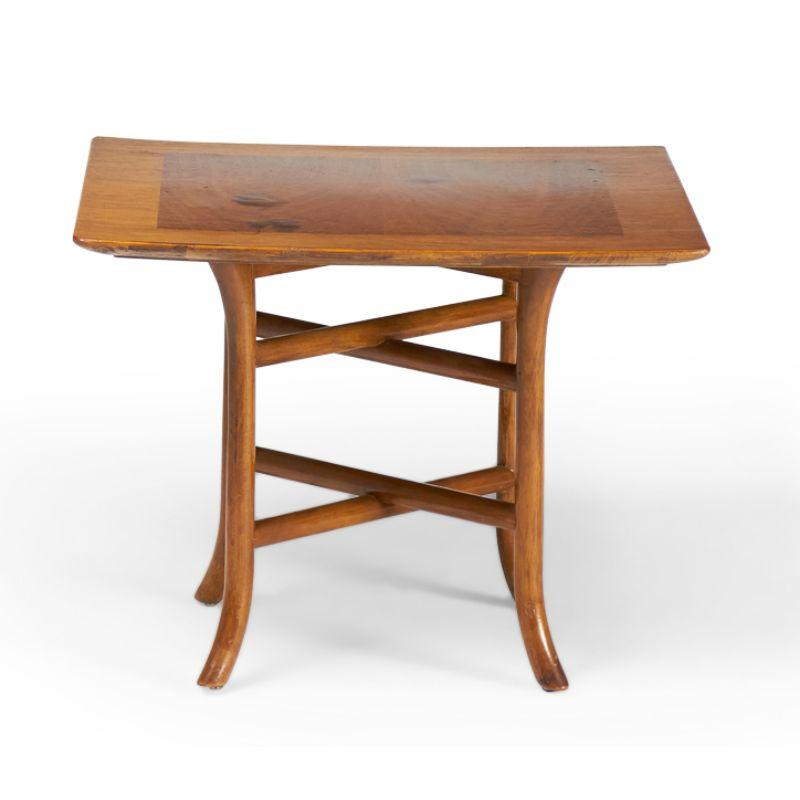 American Mid-Century (1950s) walnut occasional / side table with a square top supported by a crossed trestle base with curved sabre feet. (T.H. ROBSJOHN-GIBBINGS FOR WIDDICOMB FURNITURE)(Similar pieces with different finishes: DUF0147A-D)
